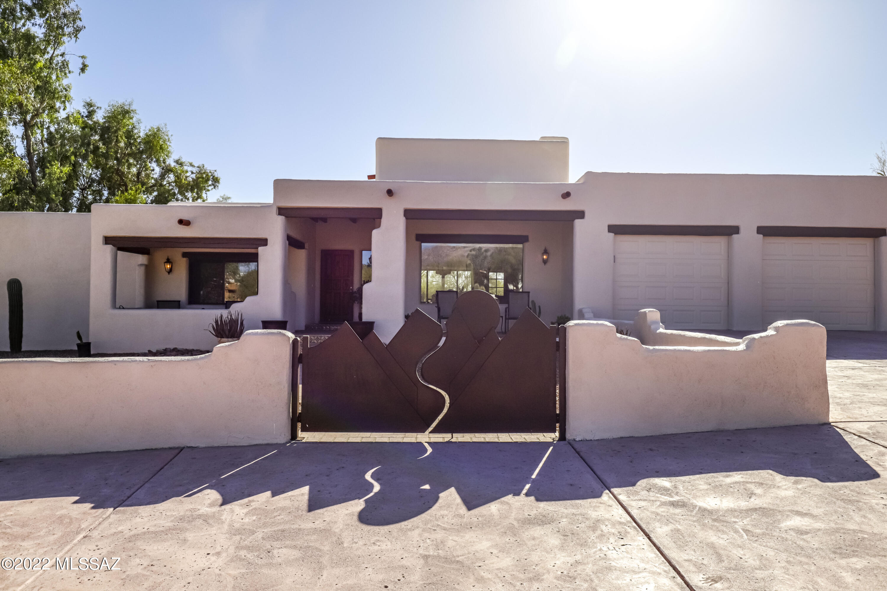 Welcome to la Hacienda. A re-envisioned Hacienda with a collection of clean walls; a visual study of its environment, where color, shape, light and shadow help create a mood of peace and tranquility in this professionally designed home. Where traditional-infused materials like the vigas and wood work promote relaxation . Once out back, you will find yourself on a huge, resort-style lanai with a built in BBQ and a romantic fireplace. The cozy, Santa Fe inspired front patio is a perfect place to relax and enjoy the mountain views and a cocktail. Once inside, you will find yourself in an architectural delight with a feeling of being in downtown Santa Fe, NM with hand carved Vigas and a light-filled family room with amazing mountain views. Down the hall is the spa-like Owner's suite.