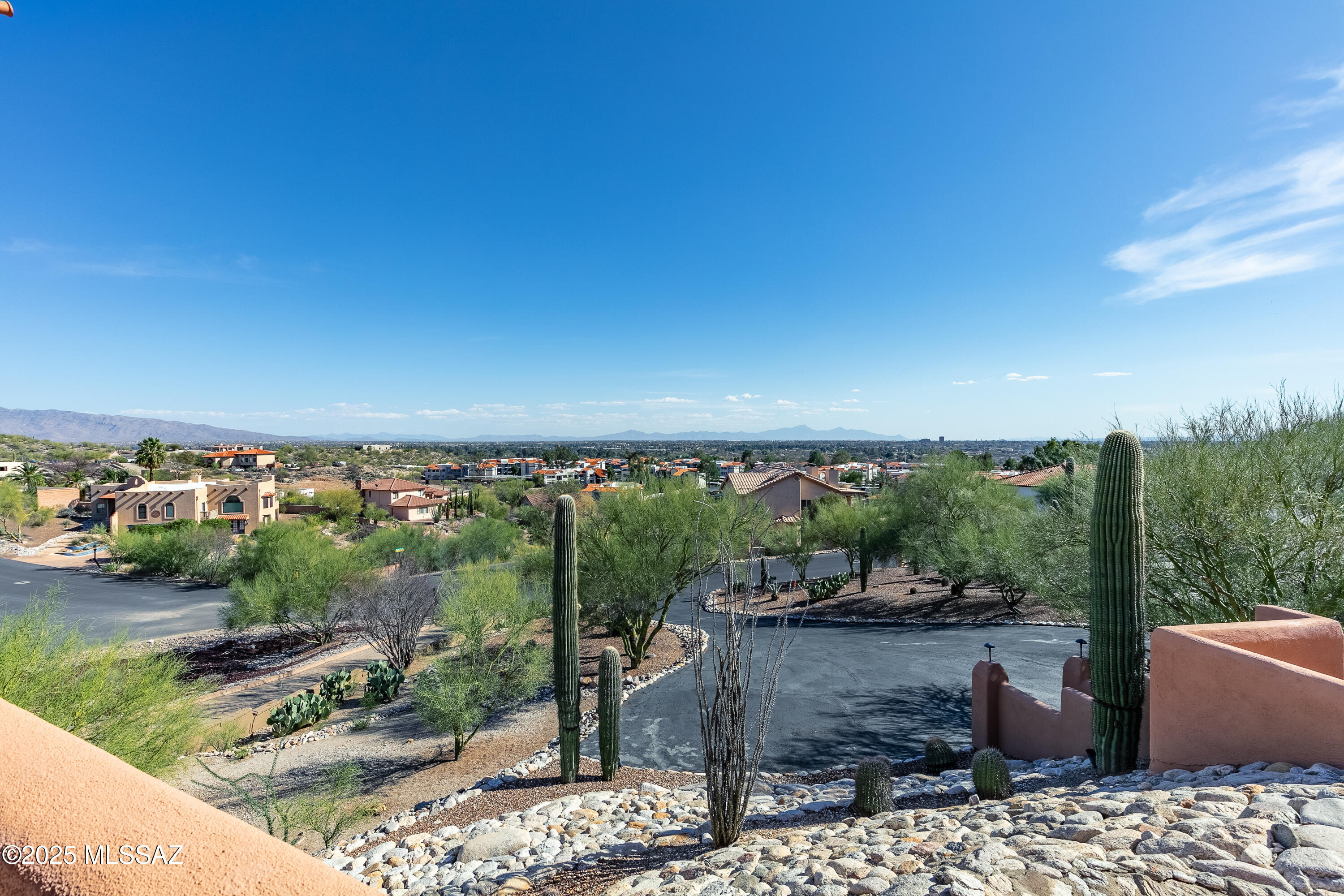Panoramic City, Catalina, and Rincon Mt. views. Meticulously maintained and repainted in 2021. Outdoor-Hill top delight,  Full Patio Kitchen w/Smoker, Pebble Tech pool,separate spa, heated. Fully landscaped. Boarders hill side common area. Split plan, 3 walk-ins, 3 Bed/3 bath. Living spaces included, living, family-(Beamed pine/cedar ceiling), dinning, optional office, enormous granite kitchen with 2nd prep kitchens.  Ice maker, two ovens, two dishwashers and more.  Waiting to be party central. 2nd prep kitchen exits to the patio kitchen and fireplace. Front patio is 35 x 10, back patio is 60 x 10. Elevated view Spa.  North side of home is all Mt. views with lights below, unobstructed hilltop views to the south, east, and north. Electric is $20-30 a month.  See agent remarks