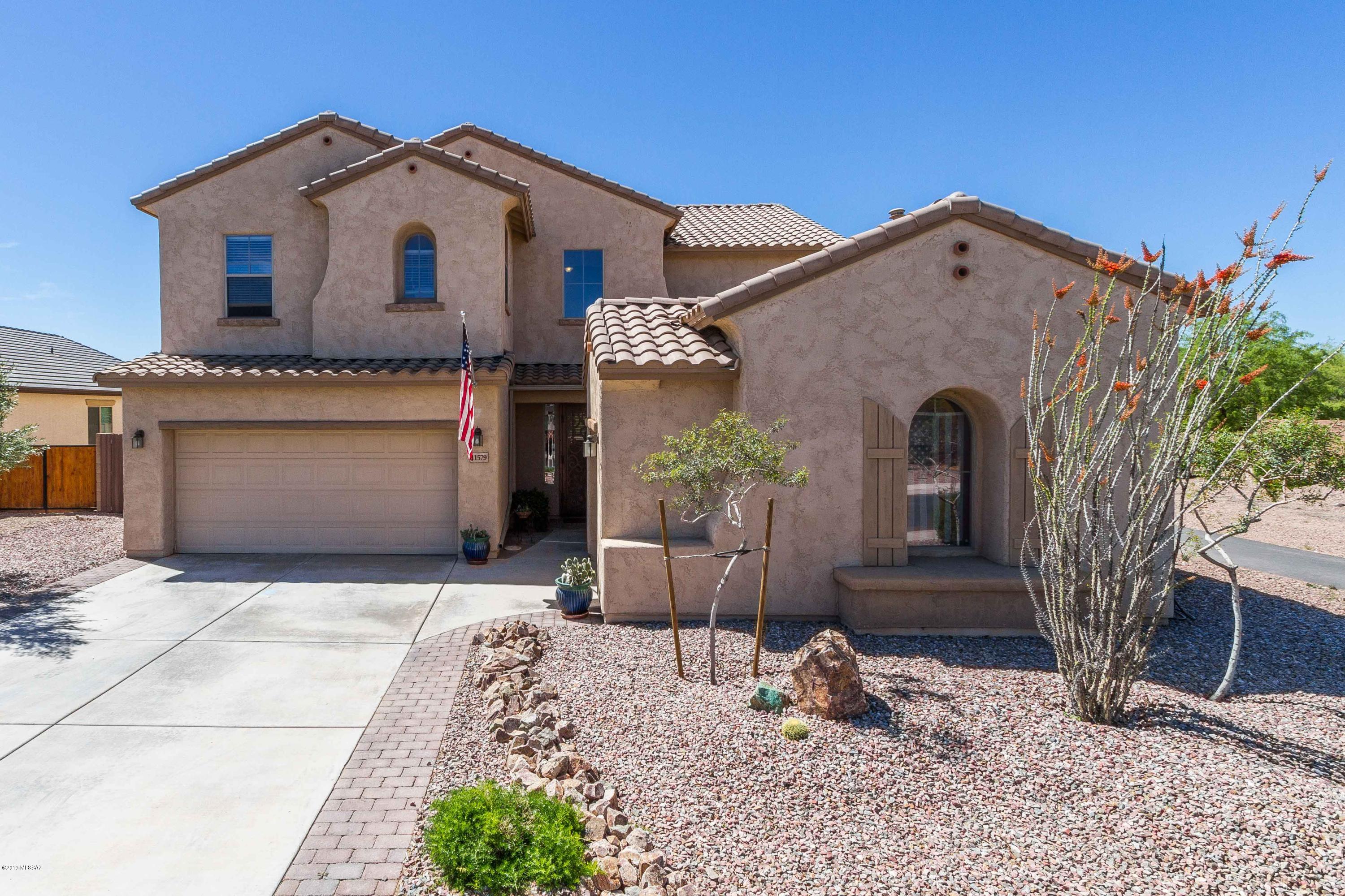 Gorgeous home loaded with upgrades in desirable neighborhood.  Flexible use floor plan includes large loft,  3 bedrooms & 1 full bathroom along w/ master suite and spacious bathroom upstairs. Downstairs has grand entryway w/ formal & informal living & dining spaces plus a bonus room & full bathroom that could easily be converted to a guest suite or be used as office/gym. Updated SS appliances in open kitchen w/ walk-in pantry.  Custom built-in cabinetry, security screen doors, travertine floors & more! Backs up to common area which makes the pool sized, fully landscaped backyard w/ Hot tub, fireplace, & extended flagstone patio an entertainer's dream. Close to Gladden Farms & Estes Elementary schools. Easy access to I-10, separate 3rd car garage, double gate to big side yard... and more!