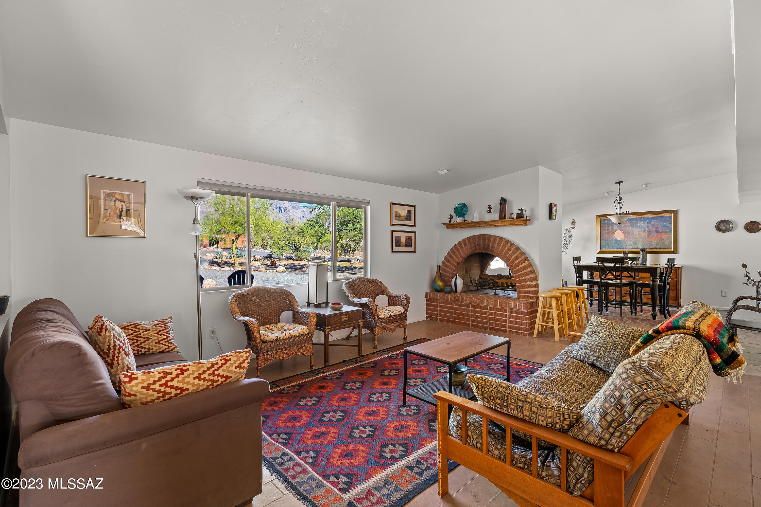 Nestled in the serene foothills at Las Brisas, the timeless charm of this mid-century modern home with clean lines and expansive views includes a kitchen with ample granite countertops and cabinetry. The central island is perfect for casual meals or a gathering spot for friends and family. One primary is secluded as a peaceful, spacious retreat with utility features. A second primary boasts ''His & Her's'' closets and the ensuite features a claw foot soaking tub and walk-in shower. The sparkling pool beckons on hot summer days, and the elevated patio is ideal for outdoor dining and enjoying sunsets. This home is a retreat from the busy world, where you can unwind, relax, and create memories. Assume VA loan at 2.25%, if qualify! Third bedroom has a walk in closet. Fourth bedroom has french doors and is perfect as an office or creative space. The smaller fifth bedroom is on the other side of the house away from all the rest. Flagstone floors throughout. Dual Zone A/C and Heating. Corner lot surrounded by cul-de-sacs. Power lines are underground, making the northern view of the Catalina mountains pure and regal. The backyard features a children's swing set, tether ball and garden beds. The charm, allure, luxury and privacy come together to make it an exceptional property