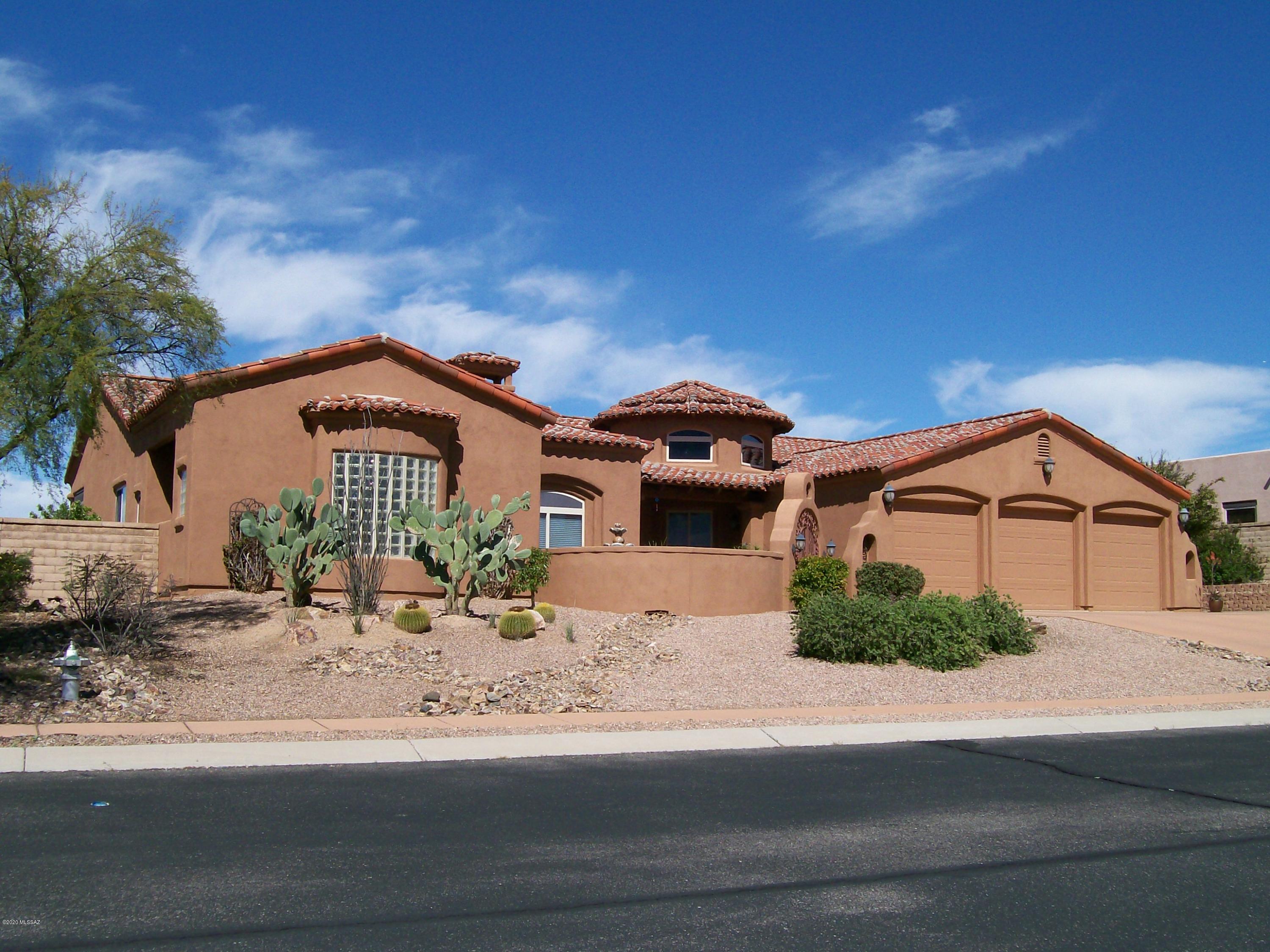 This gorgeous classic Spanish Mission style home is loaded with lots of upgrades and extras. When you enter the courtyard with fountain you automatically relax. On entering this spacious home opens up to views of the Oasis like backyard. Wonderful great room with fireplace that opens onto the gourmet kitchen with Cherry cabinetry and slab granite counter top with breakfast bar and eating area. Plus a unique round formal dining room with wood ceiling. Also separate formal living room/media room, stained concrete floors throughout except for the bedrooms. This split bedroom floor plan is great for having guests or for your children. 4 large bedrooms plus 3 full baths. See attached 3-D virtual tour and Floor plan under photos on the listing. Spacious master retreat with separate sitting area and upgraded master bath. Step into the spacious tiled screened porch that flows out to the oasis like back yard with beautiful large pebble tec pool with waterfall and in ground spa. Also a separate Sitting area with Kiva Fireplace. Beautifully landscaped with mature vegetation. Also an area of artificial grass for kids or pets. Very Private back yard with no one directly behind you. large Laundry room with lots of cabinetry, sink and folding area. large 3 car attached garage for all of the cars and toys.  Seller will give an allowance for redecorating (Interior Paint and Carpet)