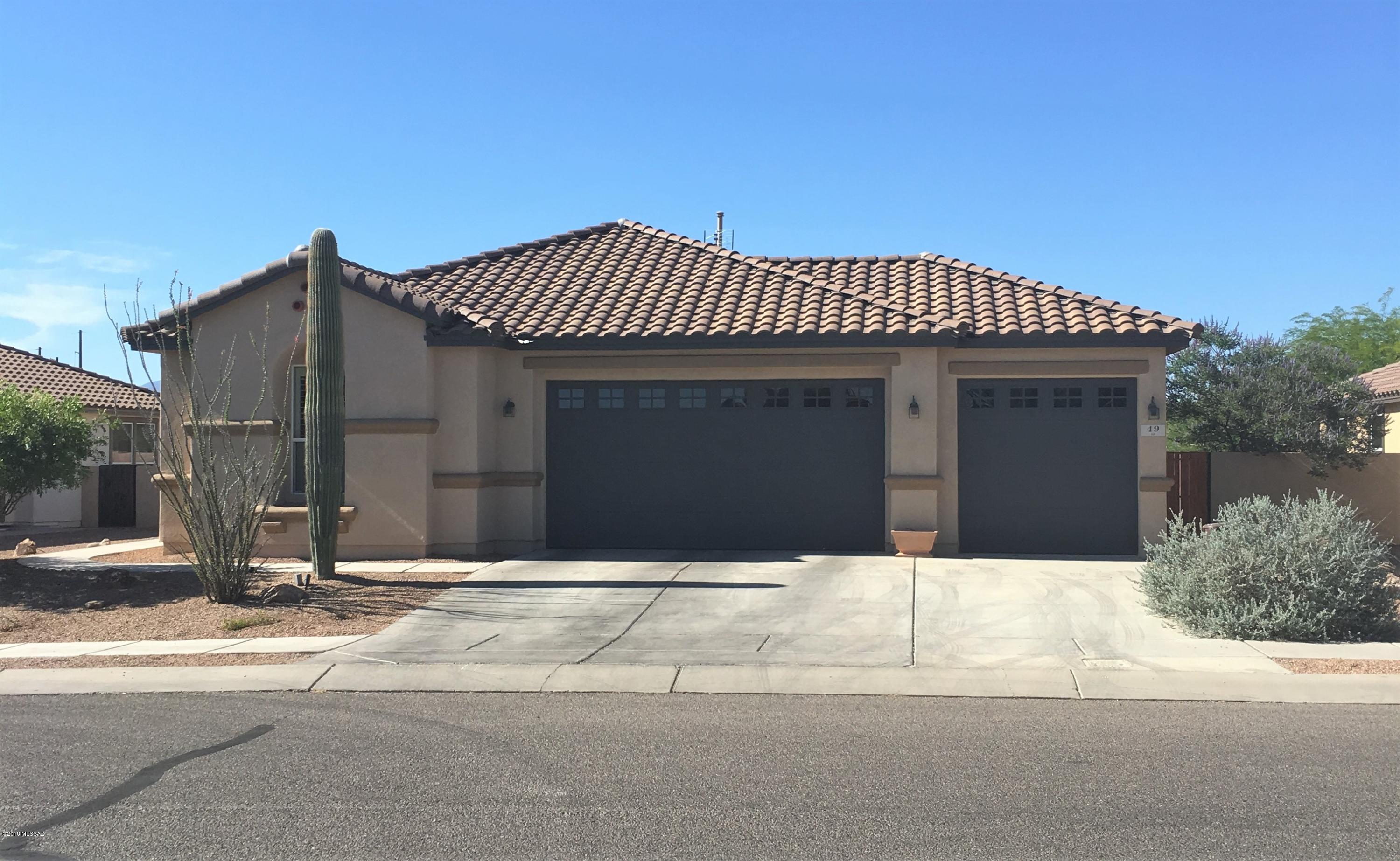 Beautifully updated home in the heart of Rancho Sahuarita. Step inside this home and you'll be impressed with all of the custom features. The living room and dining room have been completely opened to form one large great room. The kitchen is a cooks dream with granite counter tops,  beautiful custom cabinetry, with intricate wood carved details along with double ovens, and a 2 drawer dishwasher. The master bathroom has custom tile work along with a stunning double sink wood vanity. Step outside to a private yard with no rear neighbors. Enjoy the AZ weather under the full length patio, while entertaining at the built in BBQ. The 3 car garage with custom storage units gives you extra storage and room for all the toys! Don't miss this rare single story, 3 car garage home!