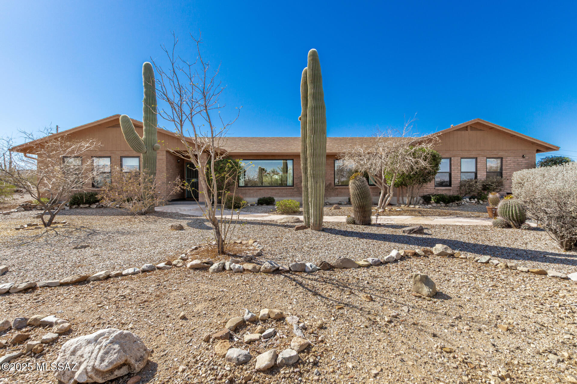 Beautifully remodeled Signature Property in the picturesque western foothills. Privacy and space abound in the sought after Bridlewood Estates. The nearly 1.2 acre lot provides for amazing views of the Tucson Mountain range as well as some gorgeous night lights after dark. This open floorplan is afforded by a reconfiguration of some interior walls and a raised ceiling that opens up the family room to the kitchen. Large picture windows were installed to capture the Catalina Mountains. All windows were replaced with dual pane Anderson windows. Bathroom vanities, showers and fixtures have all been updated beautifully. 800 sqft of guest quarters with large kitchen, living room, dining, and bedroom will provide for income property or generational living. Sparkling pool, and spa with a new heater. Huge, covered patio lines most of the back of the home for easy entertaining. Oversized 3 car garage with tall doors. What more could you want?