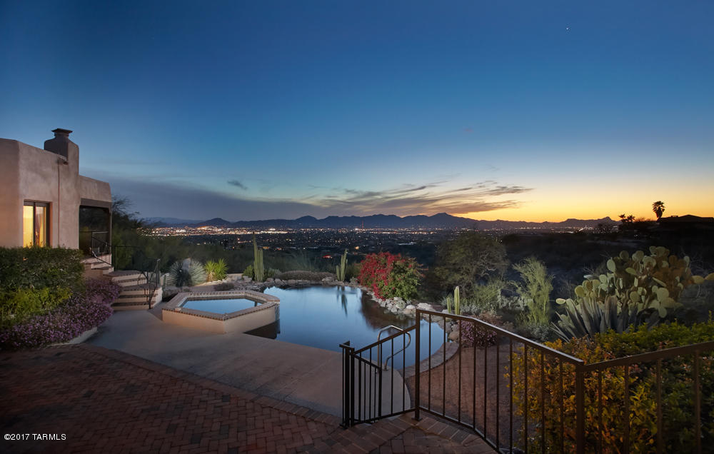 Priced below recent appraised value! Don't miss the 3D floorplan under the photos tab! Beautiful Cobblestone home with amazing mountain, sunset & city views! Lush entry courtyard! Main house is 4550sf with over 500sf detached structure formerly used as a dark room & storage! Spacious floorplan with Living Room & Family room, formal Dining Room, Library & Office/Den! Cozy fireplaces in almost every room! Wood beamed ceiling, Saltillo & ceramic tile, plus new carpet! Large master suite with private balcony to soak up the views! Master bath offers dual sink vanity, garden tub, separate shower & spa! Incredible backyard with covered patio, fireplace, pool & spa! Perfect for entertaining! You won't want to miss viewing this incredible home! Call today for your private viewing!