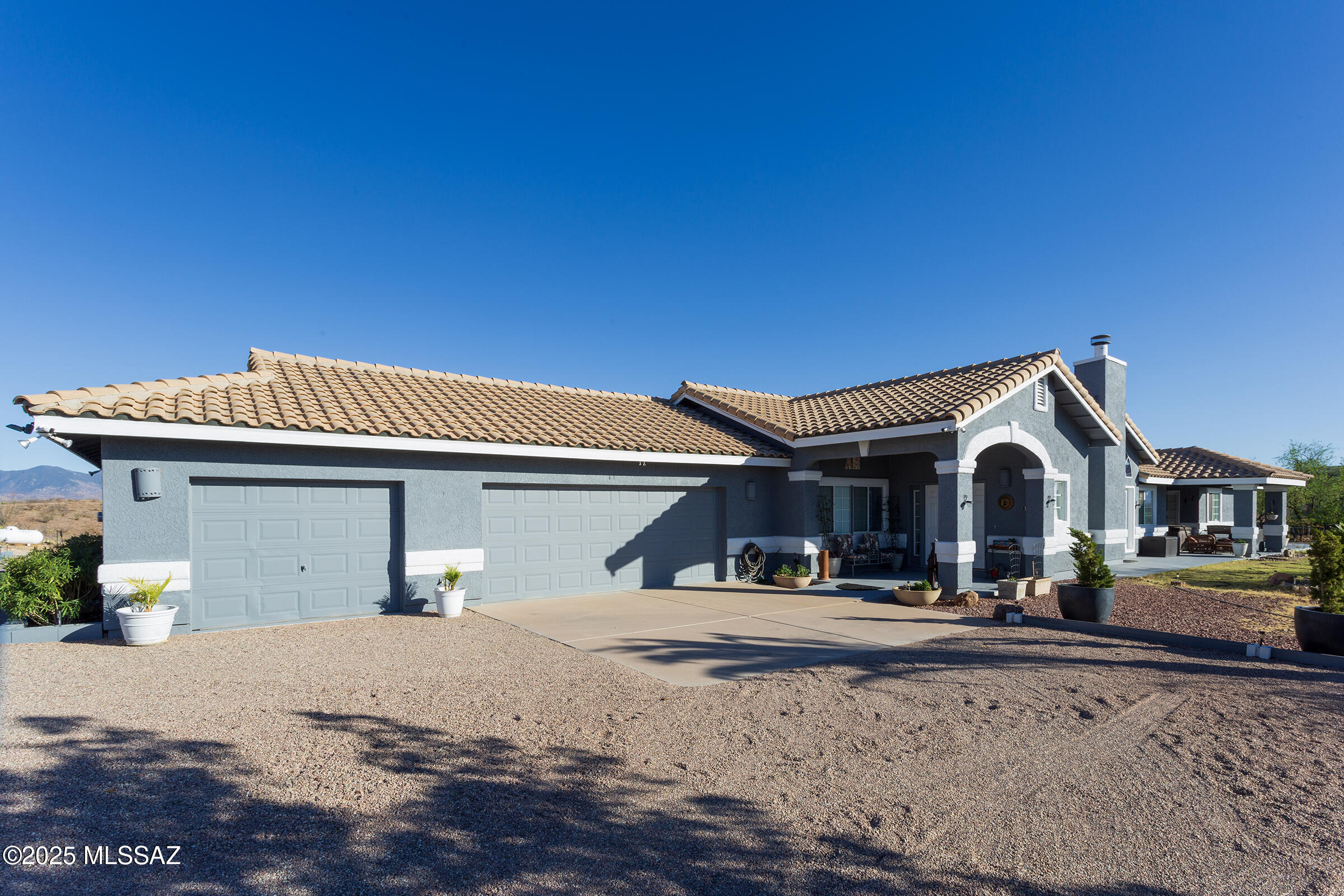 Beautiful hilltop home with panoramic views! Set on 11.4 acres, this 2,695 sqft retreat offers privacy, style & space. Enjoy ceramic tile & wood floors, a chef's kitchen with butcher block bar, gas cooktop, double oven & 2 refrigerators. Large windows fill the home with natural light & mountain views. Features include walk-in closet, spacious laundry room & built-in storage. Outside: PRIVATE WELL, patios, garden space, outdoor jacuzzi, 3-car garage, 2-4 car carport & 2 sheds. Perfect horse property on the edge of East Rio Rico & Sonoita Creek Estates. Serene yet close to town. Don't miss this rare opportunity to own a peaceful retreat where comfort meets style & nature is right at your doorstep.