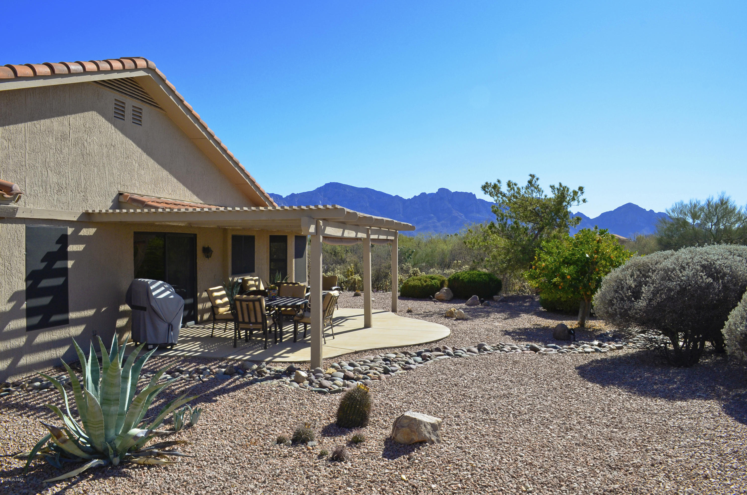 Surrounded by Pristine Natural Desert, this home offers the Rare Combination of Privacy & Catalina Mountain Views. Impeccable Cumberland Model Featuring an Open Family Room with Vaulted Ceilings. Bright Kitchen with 5-Burner Gas Range & Stainless Appliances. Breakfast Nook with Bay Windows Capturing the Mountain Views. Dining Room Accommodates a Large Table. Custom Window Treatments & Gorgeous Colored Concrete Floors Scored on a Diagonal. Spacious Master Suite with Bay Windows. Comfortable Guest Room & Full Bath. Hobby/Computer Room. Private Outdoor Living Space with Extended Covered Patio & Catalina Mountain Views. Garage with Utility Sink & Storage Cabinets. New HVAC/Furnace & 50 Gallon Water Heater in 2015. New drip system. Resort Quality Community Facilities. Meticulous Move-in Ready.