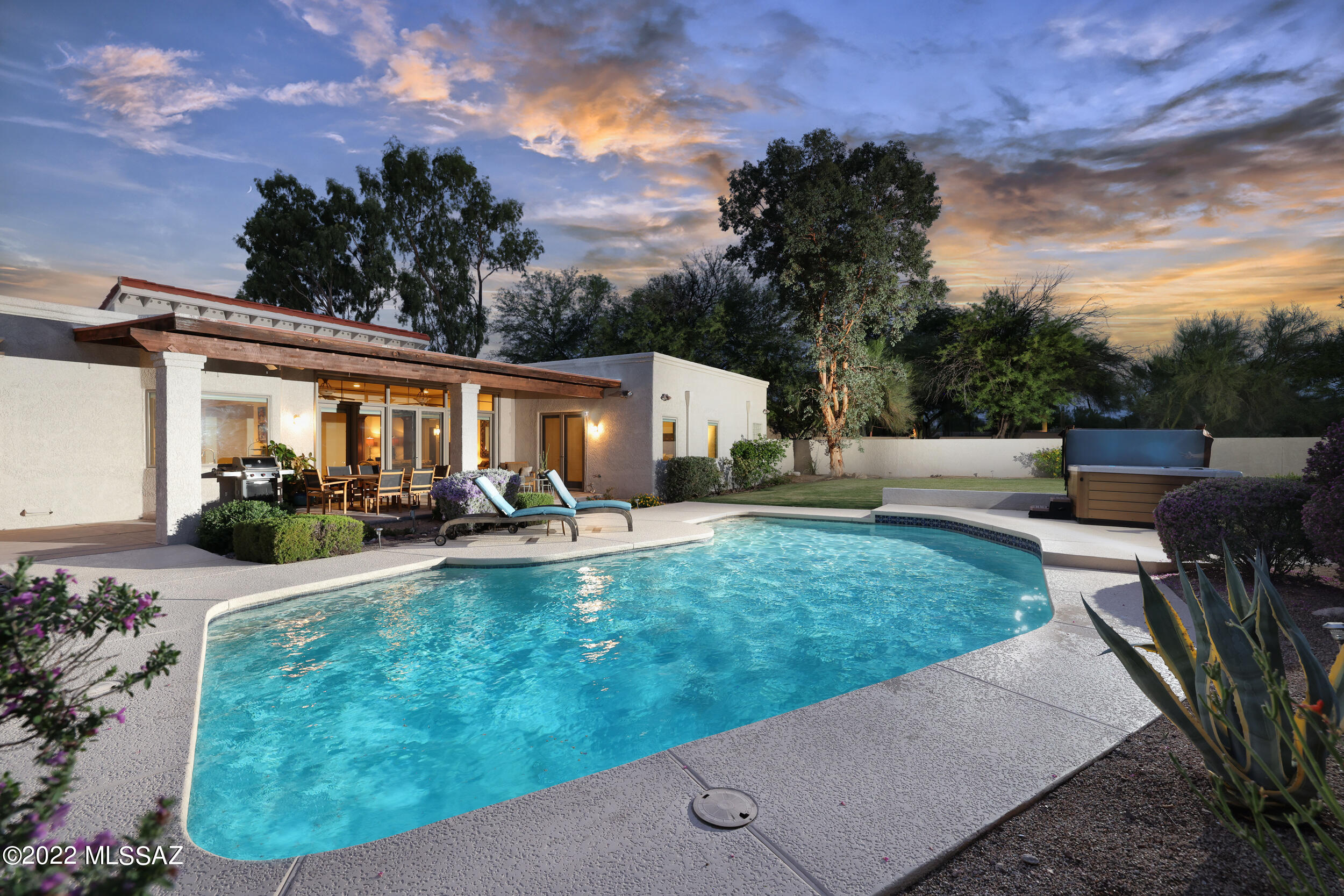 Custom home at end of a quiet cul-de-sac with gorgeous Catalina Mountain views. Located in Shadow Hills and Catalina Foothills School District. Inside you will be dazzled by the wood floors throughout, soaring ceilings, wood cased Pella windows and doors, granite counter tops, and rich wood cabinets. The kitchen features stainless steel wolf and sub-zero appliances, built-in steamer, warming drawer, large island, under cabinet lighting, custom tile backsplash. The master suite features private patio access to pool, luxurious master bath with bidet, walk-in shower, accented with travertine tile. Spacious office with expanse of custom built-ins. The yard features a large covered patio, lush lawn, mature landscaping, and a sparkling pool and portable spa. This home is a private sanctuary.