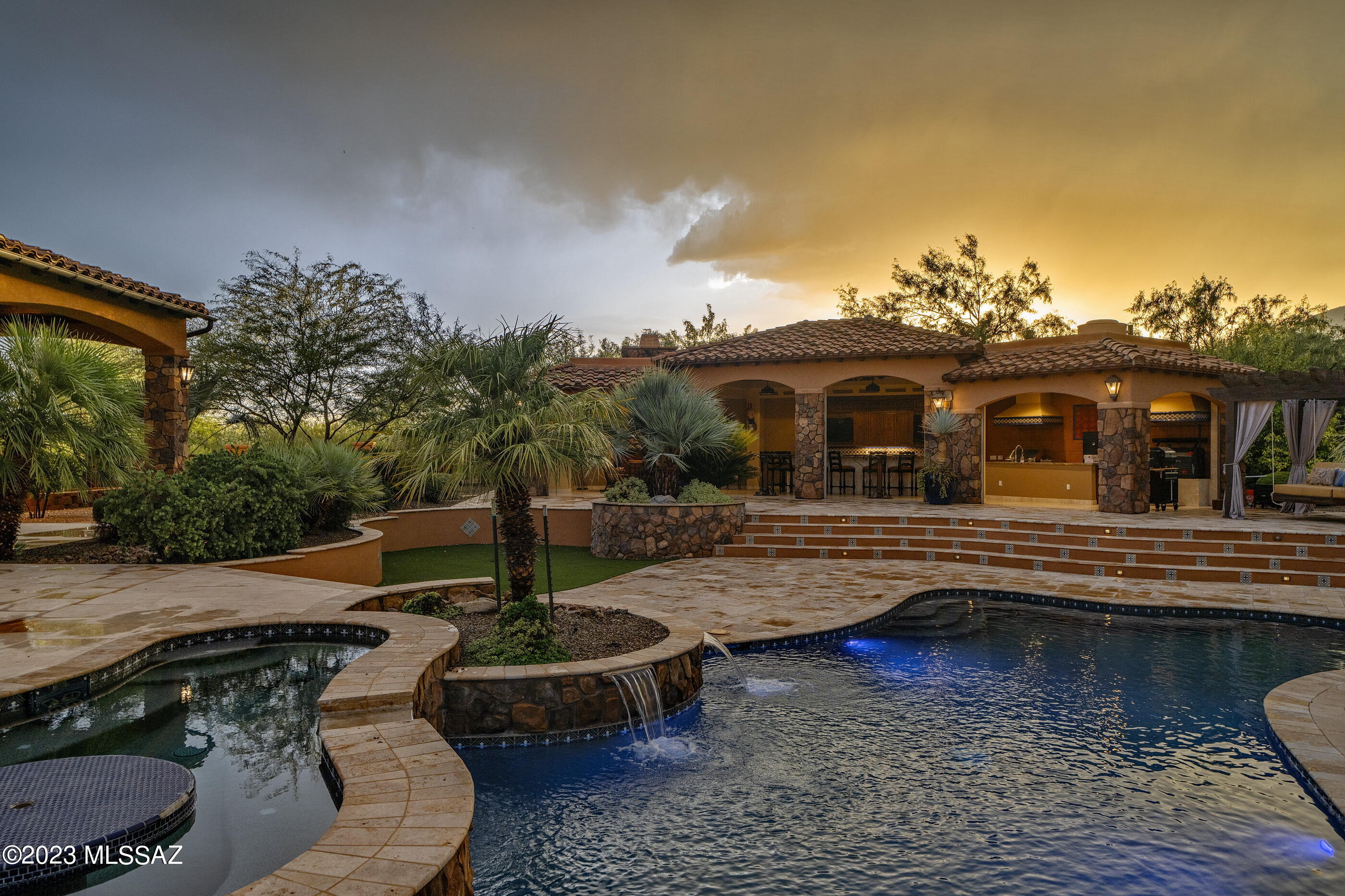 Welcome to your dream oasis nestled on a picturesque 5-acre lot, boasting breathtaking panoramic views of the Catalina and Rincon mountains. This entertainer's dream features a 995 SqFt indoor/outdoor cantina, complete with top-of-the-line BBQs and smokers, fireplace, & bath, all  perfect for hosting unforgettable gatherings. Relax and unwind by the shimmering pool and spa, or under the expansive covered patio. The elegantly designed 3700 sq ft home offers a seamless blend of comfort and luxury, featuring 4 spacious bedrooms and a chef's kitchen that is a culinary enthusiast's delight. Oversized 3+ car garage with space for two car lifts. Embrace a lifestyle of serenity in this one-of-a-kind property that captures the essence of privacy and stunning views with easy access to amenitie