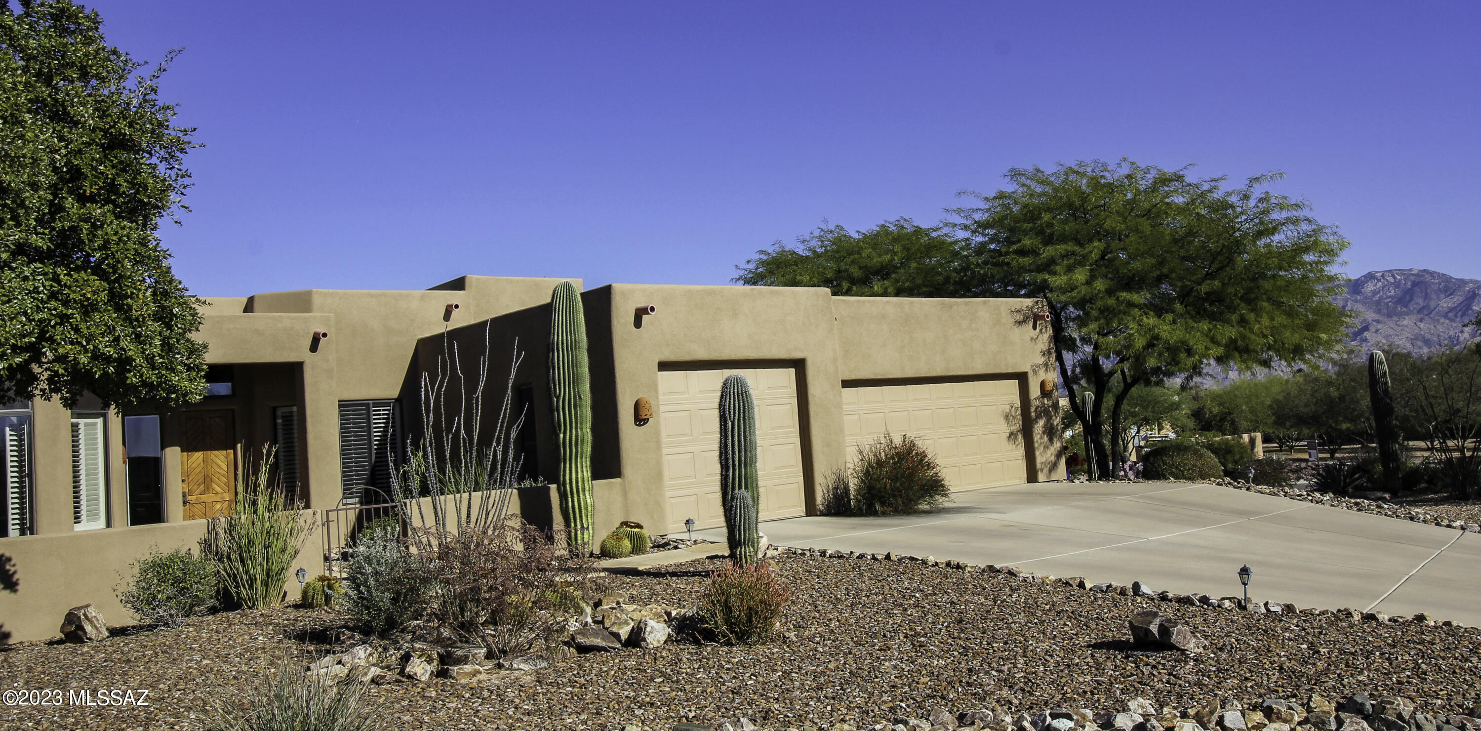 Beautiful custom home in Oro Valley with a true southwestern design includes high viga beamed ceiling, an open and airy great room floorplan with split bedroom design, both casual and formal dining, plus an open office and den/sitting room to get away from the noise to read a book. Special features include dovetailed cabinets, tile floors throughout, solid wood interior doors, and plantation shutters.

With north-south facing exposure, enjoy panoramic views from the large covered patio, or a swim in the solar heated Pebble tec pool with beautiful Santa Catalina Pusch Ridge Mountain views. Let's not forget the 3-car garage with exceptional storage and epoxied floors that are spotless. Our meticulous sellers will get your buyers saying YES, lets buy this home!