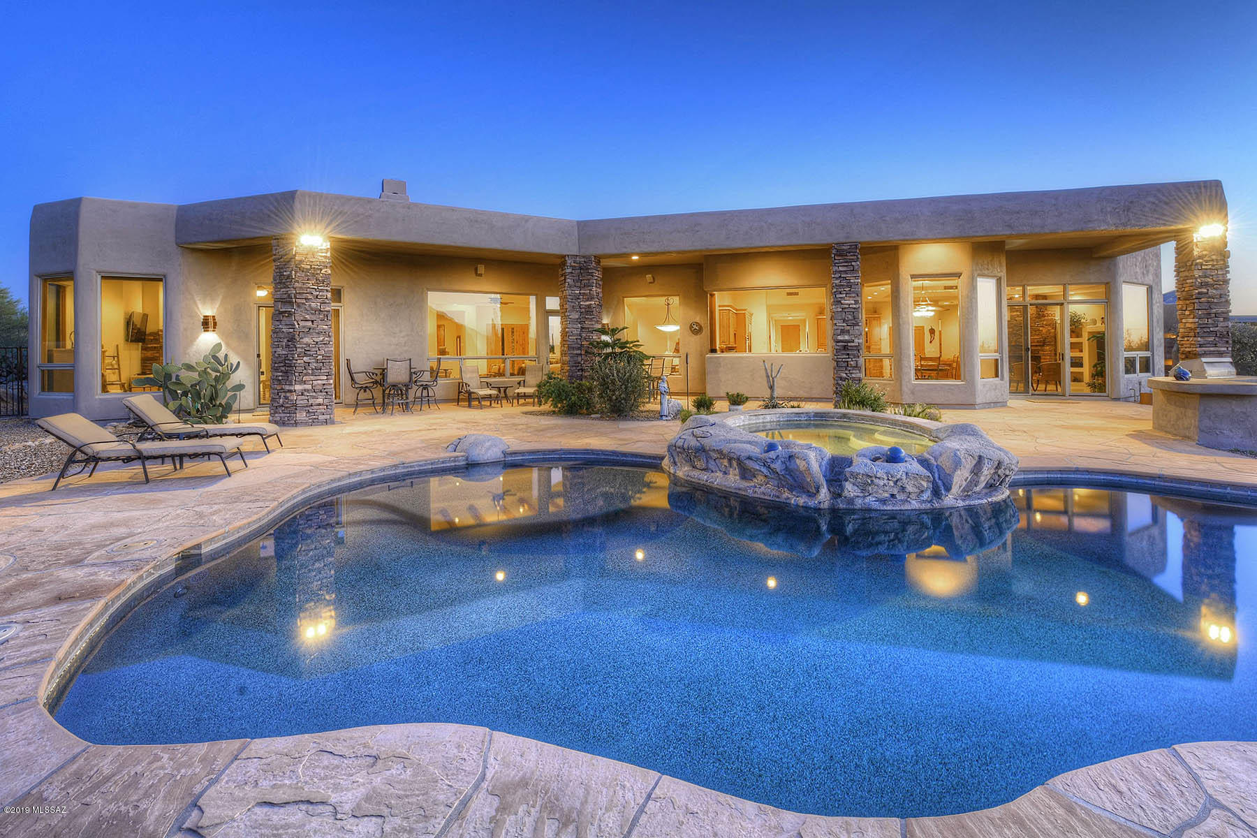STUNNING SOFT CONTEMPORARY NESTLED AMONG A FOREST OF SAHUAROS W/BREATHTAKING MT &  CITY VIEWS ON ONE OF THE FINEST HOMESITES IN PRESTIGIOUS GATED PIMA CANYON. FOYER ENTRY, EXQUISITE LIVING RM W/HIGH CEILINGS, WALLS OF WOOD CASED WINDOWS, DRAMATIC FIREPLACE, FORMAL DINING RM, GOURMET ISLAND KIT W/GRANITE COUNTERTOPS, STAINLESS STEEL APPLIANCES, GAS STOVE TOP, DOUBLE OVENS, REFRIGERATOR, PANTRY, BKFST AREA OPENS TO FAMILY RM W/STONE FIREPLACE, TRAVERTINE FLRS, FRENCH DRS,  5 BDR'S/4 BA'S, (MSTR  W/ SITTING AREA, FIREPLACE, LUX BATH W/ TRAVERTINE COUNTERTOPS, DBLE SINKS , JETTED TUB, SHOWER, WALK IN CLOSET & PRIV ENTRY TO REAR PATIO). RESORT LIKE BKYD W/ COV'D FLAGSTONE PATIO, GAS HEATED POOL, SPA, FIREPLACE, BBQ, LUSH LANDSCAPING, 3 CAR GARAGE, MT  VIEWS! FLR PLN UNDER PHOTOS/VIRTUAL TOUR.