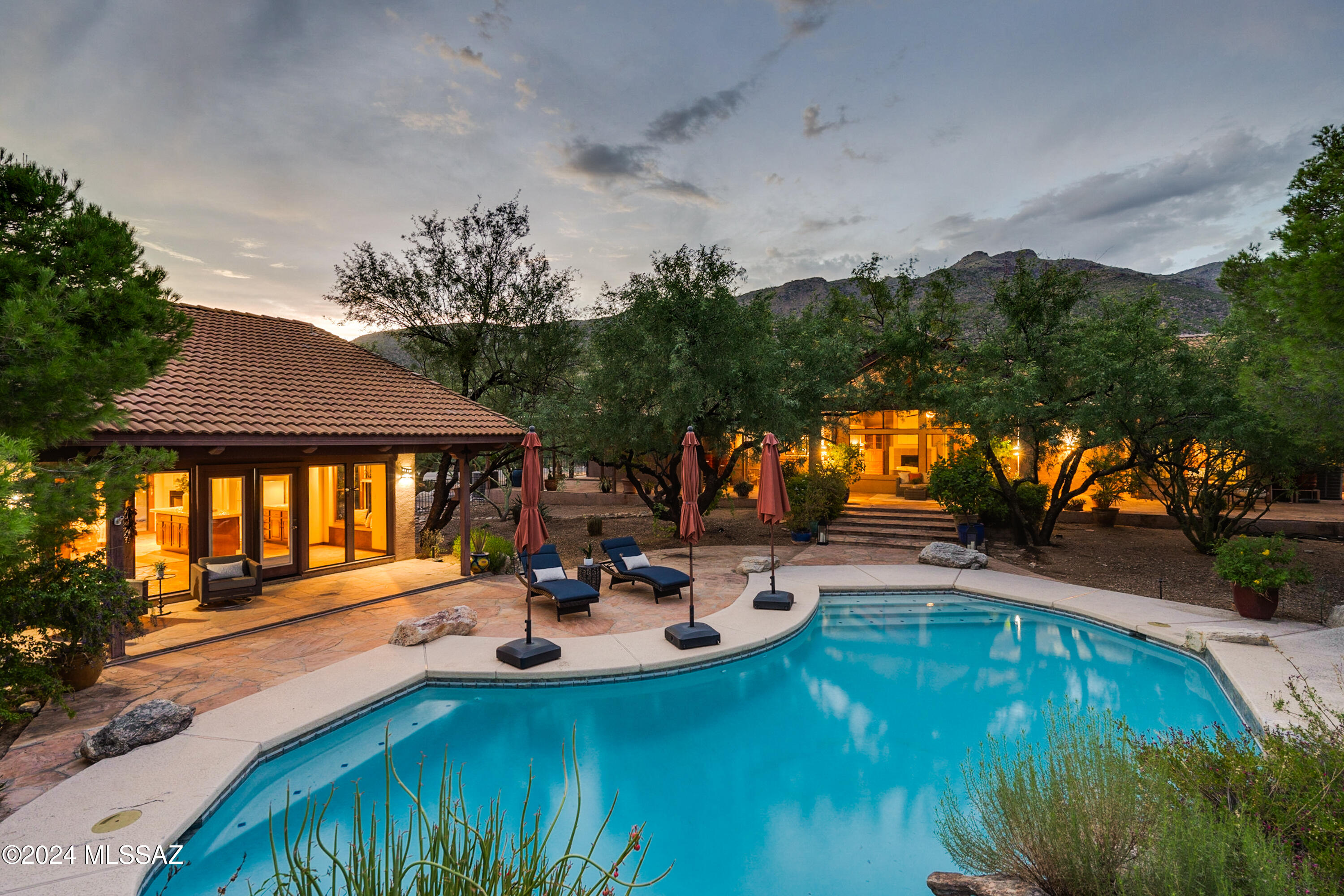 Spectacular resort lifestyle property nestled in the highly sought-after Tanque Verde Valley. Situated on a sprawling, private 3.19-acre lot, this tranquil property offers breathtaking panoramic Catalina Mountain views and lush, serene surroundings. As you enter the inviting courtyard, you are welcomed by charming fountains, elegant flagstone pathways, and a vibrant botanical garden, setting the tone for the beauty within. Inside, the home features an architecturally appealing floorplan that exudes warmth and sophistication. The dramatic family room boasts soaring cathedral wood ceilings and a wall of windows that perfectly frame the backyard oasis, bringing the outdoors in. The open-concept kitchen seamlessly flows into the family room, making it an ideal space for entertaining. It's equipped with stainless steel appliances, granite countertops, and ample prep space, all accentuated by a picturesque window that overlooks the serene backyard. The living and dining rooms provide additional space for entertaining, with both areas offering access to the courtyard and captivating views of the Catalina Mountains. Generously sized bedrooms provide comfort and privacy. The expansive primary suite features a well-appointed en suite bathroom with a double vanity, walk-in shower, and private patio. Secondary bedrooms offer tranquil views of a Zen-inspired botanical cactus garden, beautifully accented with soft lighting. 

The backyard is a true resort-style retreat, with multiple seating and entertainment areas designed for relaxation and social gatherings. The upper-level patio boasts an expansive covered space, offering stunning views of the tranquil yard, refreshing pool, serene rock waterfall flowing into the pool, and the lush Sonoran desert from every angle. A true nature lovers paradise you will see deer,coyotes, javelina, owls, falcons, hawks, many species of hummingbirds and Butterflies to just name a few. 

A separate guest home adds versatility to the property, providing an ideal space for guests, a studio, or a home office. This charming guest house features Saltillo flooring, attractive Talavera countertops, an open kitchen, and a built-in Murphy bed, along with both a porch and a private patio. Homes like this are a rare find, offering the perfect blend of indoor and outdoor living, with spectacular views from every window. Additional features include ample storage in the three-car garage, with extra space and a separate shed outside. 

Saguaro National Park is a 10 min drive with the most cactus you can imagine seeing in your lifetime. Picacho Peak is a short drive with the most amazing hiking, photography, and wildflowers the southwest has to offer. Living at the base of one the most magnificent sky islands in Arizona. Mount Lemmon has an exciting and spectacular million-dollar drive to the peak with skiing in the winter and hiking, mountain biking, and boating in the summer in the alpine forest. Enjoy the picturesque sunsets from Windy Point Vista too!

Come entertain in luxury and make this desert oasis in the Tanque Verde Valley your own today!