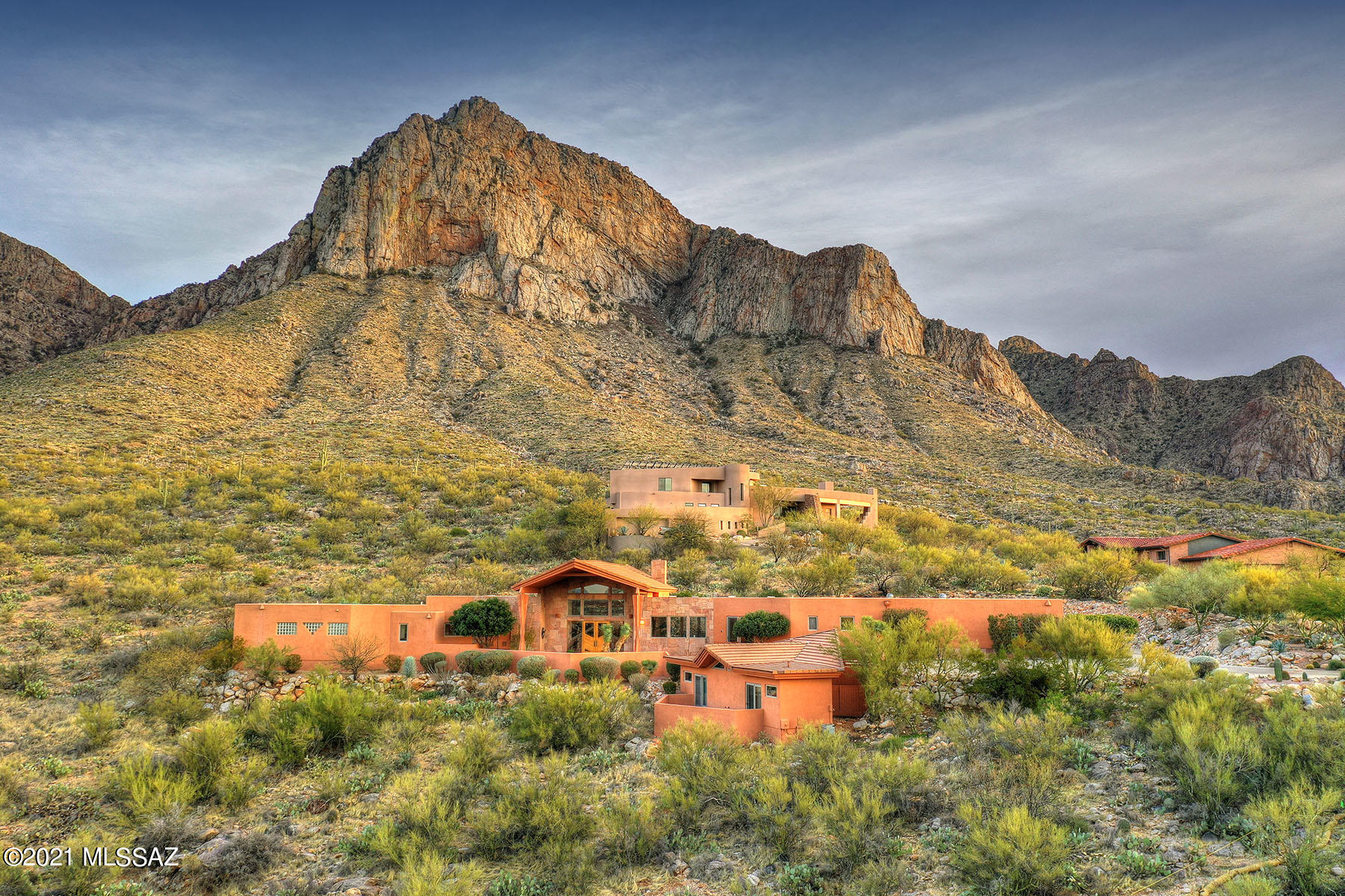 Impressive architecturally designed Contemporary home situated on 4+ acres high in the mountains of La Reserve, a private gated community in the heart of Oro Valley. Spectacular views all around from this stunning home with vaulted ceilings and amazing glass windows. The house has 3 comfortable bedrooms and 4 bathrooms. A separate guesthouse w/ patio provides another 2 bedrooms, with bathrooms in suite, which can easily be converted into an office. Enjoy the magnificent sunsets in the evening sipping your drink at your home bar looking over the Valley. Enjoy outdoor living with a s/s barbecue, a hot tub, and a fire pit for star gazing evenings. Master suite reveals the beautiful mountain sunrises as you raise the electronic blinds. Master bath offers dual vanities, a large soaking tub + spacious shower and private commode with a bidet. 2 large walk in closets offer plenty of hanging space. Gourmet kitchen w/sub zero fridge, trash compactor, dishwasher, double convection oven, microwave, and spacious walk-in pantry. Huge Great Room w/arched ceilings has a gas fireplace and auto solar blinds on back windows to keep the house cool. Large 3 car garage with separate storage room. Intercom system throughout the house and the guesthouse. Monitored security system throughout. Irrigation system maintains beautiful landscaped garden. AC system has a maintenance contract.