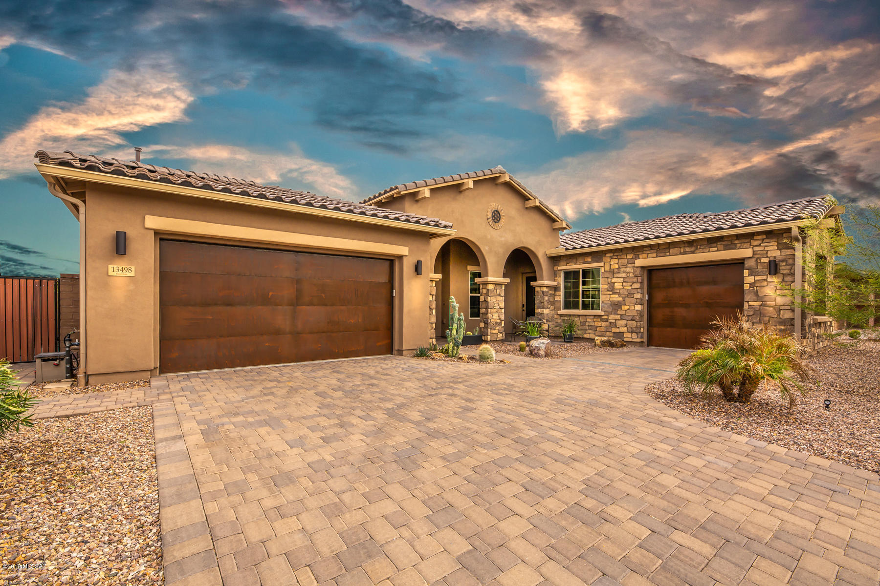 A true piece of art, this custom-built home located in the prestigious gated community, Center Pointe at Vistoso in Oro Valley known as a Cyclist and Golfer's Paradise!  This home has all the extras, including breathtaking views of the Catalina's and a private luxurious guest suite with its own entrance.The gourmet kitchen features an extended quartz counter, top of the line appliances and warm lighting. The large open concept floor plan flows into the resort style back yard built with entertaining in mind.  Take advantage of the full outdoor kitchen with dining area to enjoy the sensational Arizona weather year-round.  Relax in the heated salt water pool/lagoon and spa, work on your golf game or just have some fun with the family on the 3-hole putting green. This energy saving Smart Home has keyless locks, in wall central vac, HVAC with three separate zones and a Life Source eco-friendly water system.  All bedrooms feature their own private bathroom, upgraded showers and walk in closets.  Large playroom or gym off great room plus another bonus room off master, which can be used as a home office. Community amenities include massive pool, spa, children's playground, sport park complex, interconnected trail system, access to Tucson cycling loop, Honeybee Canyon, mountain bike trails, hiking trails and more.