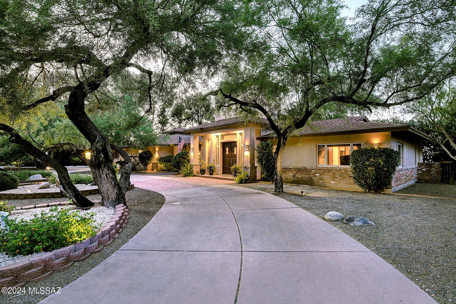 Stunning and gracious remodeled home situated on a lushly landscaped 1/2 acre homesite in prestigious gated Tucson Country Club. Double door foyer entry, exquisite Great Room w/16 ft. high ceilings, dramatic stone fireplace, built-in lighted art display bookcases, formal dining rm w/wet bar, 2-way fireplace, sensational gourmet island kitchen w/gorgeous granite countertops, breakfast bar,  stainless steel appliances, gas stove top, double ovens, extra prep sink, refrigerator, wine cooler, pantry, solid wood plank floors, incredible library/study w/18 ft. high ceilings, walls of bookcases, 5 bedrooms (split plan), 5 baths, tile floors, wood cased windows, a charming Secret Garden , pantry/laundry room. Enjoy the fabulous backyard w/covered patio, pool, gazebo, fruit trees & serene setting