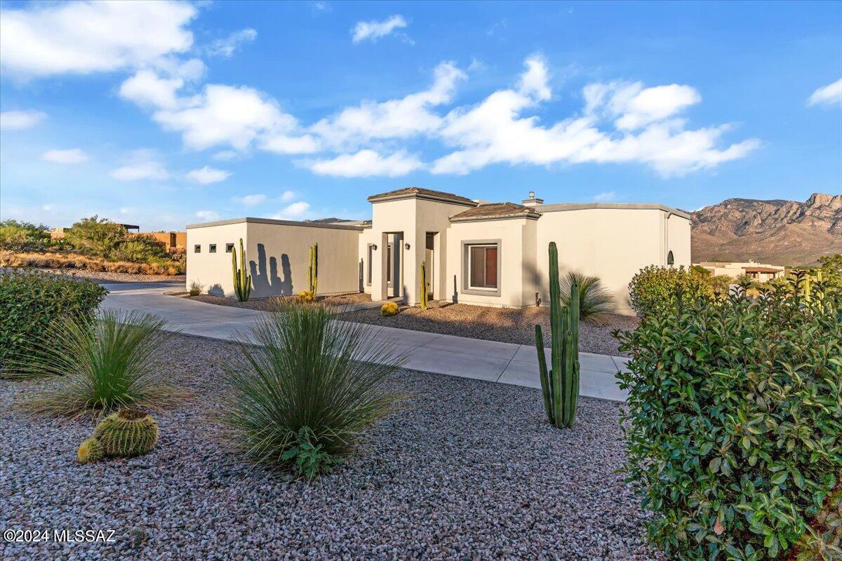 Incredible custom home on over an acre with panoramic views of Pusch Ridge. Sit on your expansive patio and watch the changing mountain moods. This house was built by the current owner to exceedingly high standards.
The kitchen features granite counters and stainless appliances with a commercial gas range. The living room has a gas fireplace and expansive windows to take in the views. Go downstairs to a large finished basement with a bar, Bonus room, 2more bedrooms and a bath. Walk out of the basement on to another expansive patio. Bring your toys because this house has a RV garage and a workshop that is air conditioned and includes another half bath. This home is truly one of a kind, come take a look!
