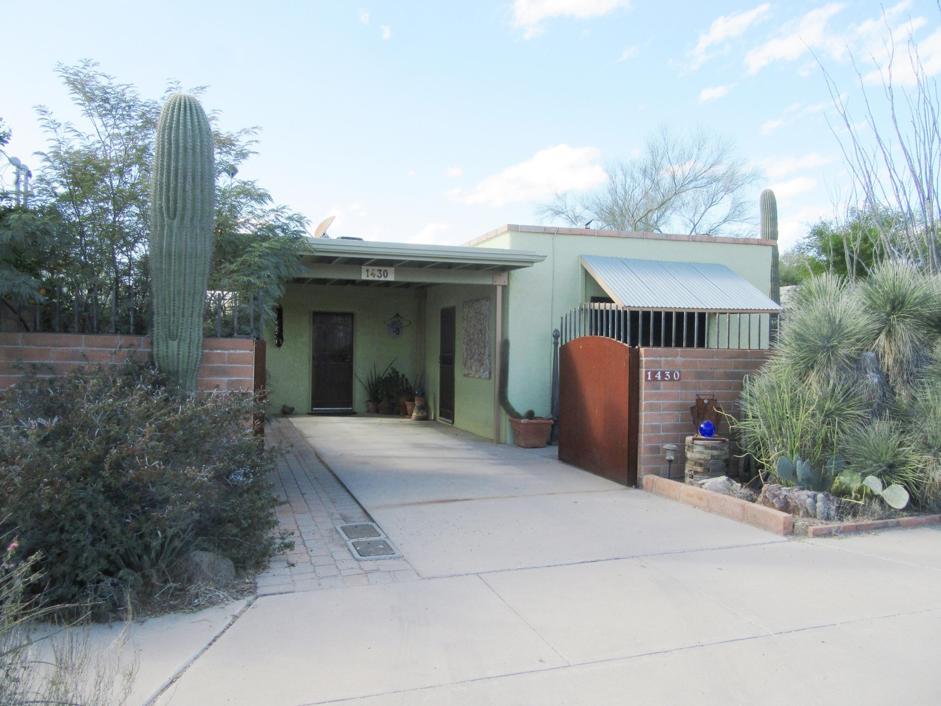 Immaculate home in historic ''A'' Mountain neighborhood with 1948 character was gutted and totally remodeled in 1987. Seller has lovingly maintained & updated it ever since. See SPDS and attached addendum for many  upgrades. Close in to town but quiet and super-private lot, with views of Tumamoc Hill and ''A'' Mountain fireworks. Wholly owned solar panels for very low electric bills, water harvesting for your landscaping needs, and other green features. Lot is compilation of 3 original parcels, which are separately fenced. Enjoy your many saguaros, shrubs, & trees! Backyard of home features a patio & a garden area.  1730 gal water harvesting cisterns provide water for plantings, and swales passively direct rain where you want it. Your new home awaits! Click ''More'' link for addl info Through the wooden fence behind the main backyard is another secluded yard with desert plants and yard art (which stays), with even a 3rd area through the chain link beyond. Steel gates secure your car in the carport, and home has alarm system for added security. Roof is freshly coated too. "A" Mountain Community Association is VOLUNTARY, and offers scholarships to neighborhood graduating seniors.