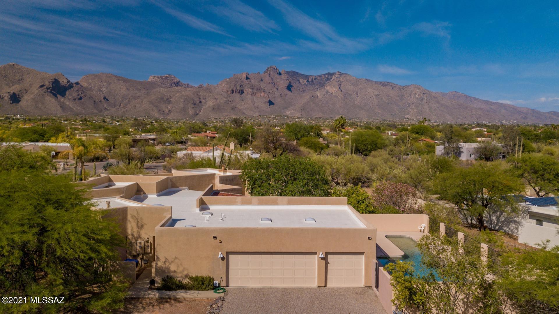 Enjoy dramatic Catalina Mountain views from this beautiful Foothills home, located in the highly sought after Shadow Hills community. Open and bright with 3bd + den/4bath, high ceilings, and two fireplaces. Large rooms with abundant storage and a roomy 3 car garage. Each bedroom has it's own patio to the outside. Private back yard with huge covered patio, an outside staircase to a viewing deck, a lap pool, and mature landscaping make this a great family home with mountain views in the heart of Catalina foothills. Estate Sale will be held on July 3rd. Home has a lot of sale items displayed throughout.