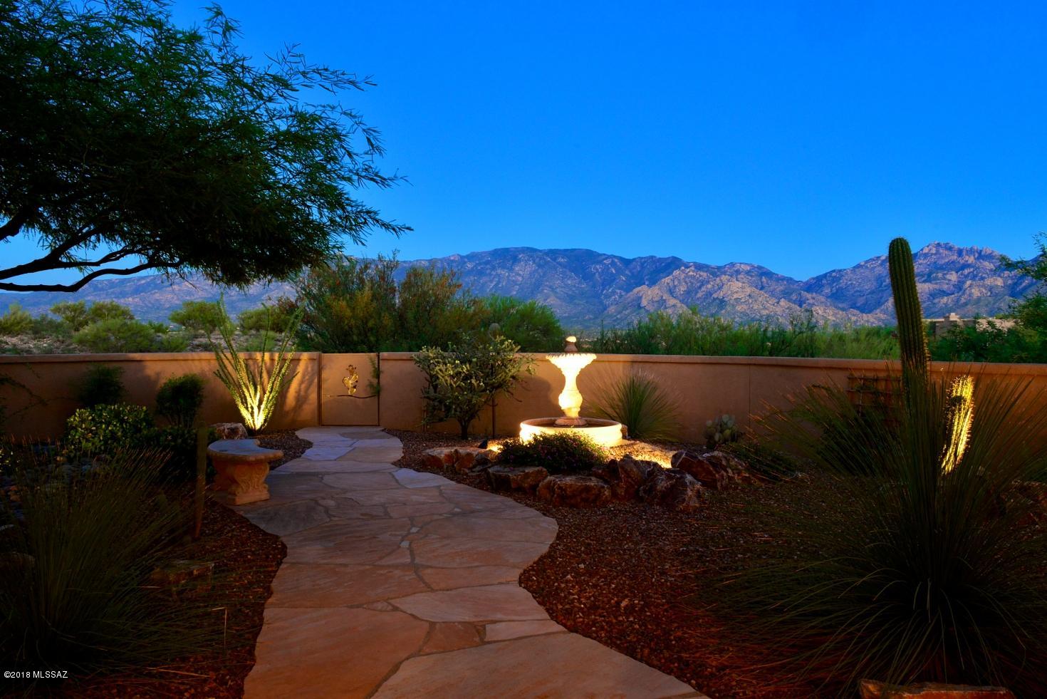 Looking for the quintessential AZ lifestyle? Elevated setting with privacy offers panoramic Catalina Mountain views over open desert! You'll be captivated by the views and soothed by the comfortable open great room styling. Designed for easy living and gracious entertainment, this 3330 SF home with 3BD, 3BA, Den (or 4th BD), 2 Fpls, Wetbar & 3-car Garage in gated High Mesa in Oro Valley's Rancho Vistoso development evokes a sense of relaxation and well-being. Luxury amenities: chef's kitchen with gas cooktop & 2 ovens, tile flooring in public areas, formal dining, inviting master suite, coffered ceilings, lots of windows. L-shaped covered patio and beautifully landscaped yard (room for pool) offer sweeping east-facing views and ideal setting for enjoyment of a uniquely Tucson lifestyle!