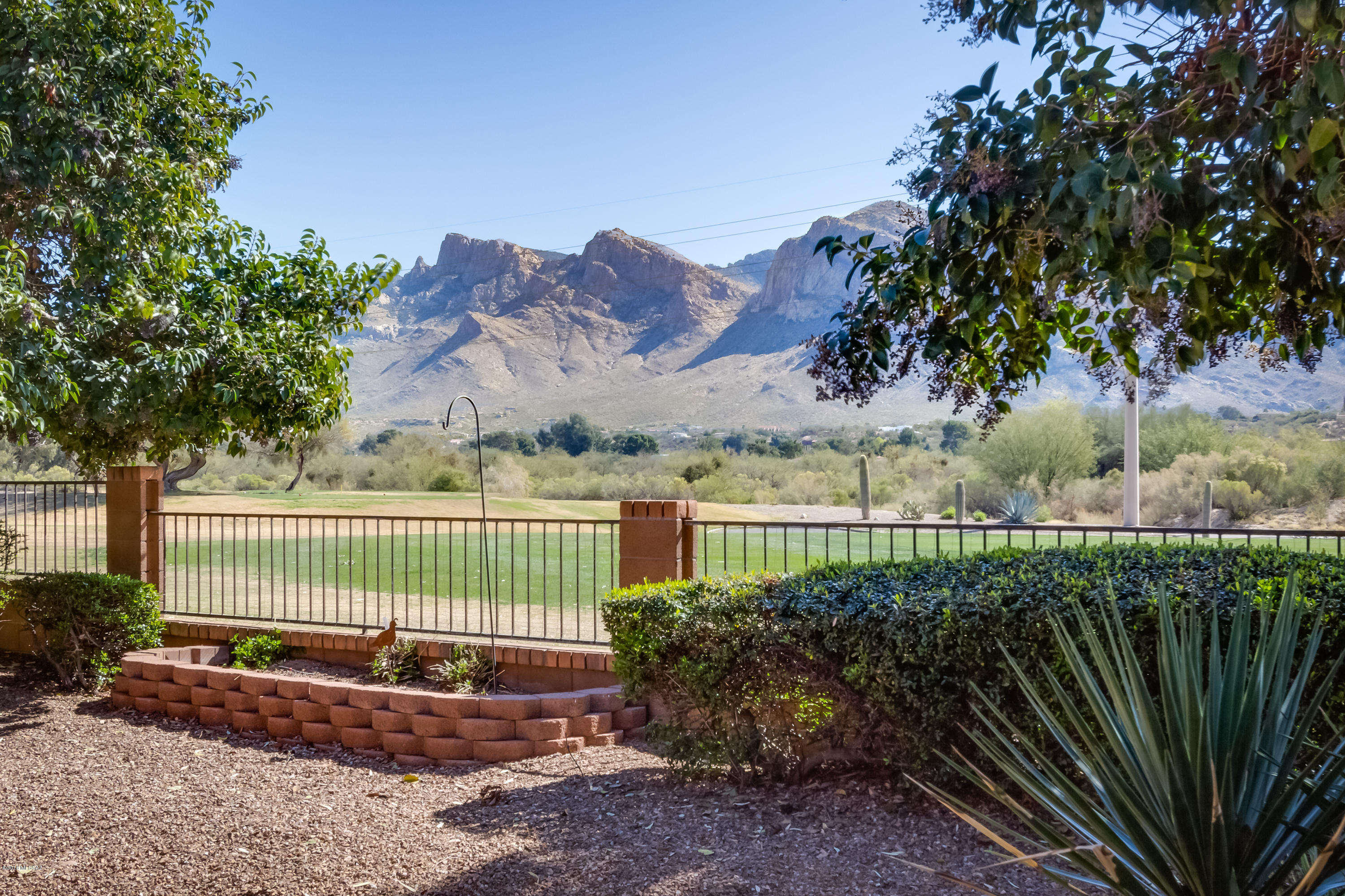 Gated Villages of La Canada single story 1,893sf 2BR/2BA + den & bonus room on 11th fairway w/Catalina Mountain Views. Kitchen has breakfast bar, breakfast nook, stainless appliances & smooth top electric range. Family Room off kitchen has corner fireplace. Formal Living/Dining area. Master suite has glass door to patio, double sinks in vanity, large tub. Tiled Shower, & walk-in closet. Cork tile floors, wood blinds, vaulted ceilings, Ceiling Fans, Security Screen doors. Back yard has planters, mature trees, extended covered patio, & backs to golf course with amazing Catalina Mountain Views. Close to Restaurants, Cafes, Shopping, Oro Valley Community Center w/Fitness Center, Tennis, Golf, Swimming, Pickleball, Canada Del Oro Riverfront Park w/Volleyball & Lambert Park. 3 car garage.