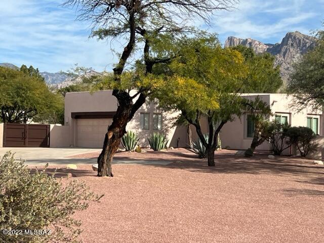 BRAND NEW INTERIOR & EXTERIOR PAINT!  2.2 ACRES of prime Oro Valley real estate.  Fantastic Cul-de-sac location in the back of community - divine privacy & quiet. Large gated courtyard greats you as you enter this SINGLE story 4 Bed, 3 Bath & just shy of 3,000 sq ft. Split bedroom, lavish outdoor living space, pool, mature landscaping. Fenced EAST facing backyard w/ huge patio & gorgeous MOUNTAIN views. BIG TICKET items addressed in excess of $230k.  Ceramic wood like flooring, newer windows, pex plumbing, sewer line replaced, NO POLY, both ACs & Heating systems only 2 years old, roof just re-coated, newer water heaters, upgraded kitchen w/ commercial appliances, custom iron double gates to rear yard = full upgrade list attached.