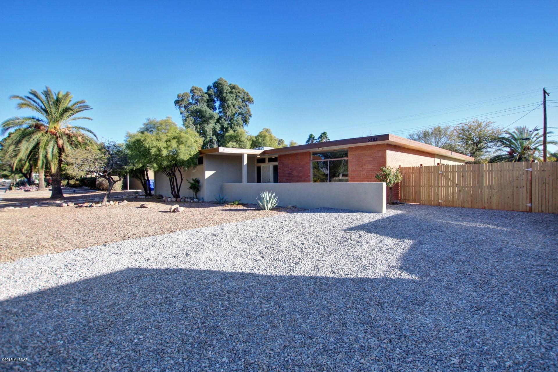 Beautifully remodeled brick home on huge 0.23 acre lot with guest quarters. Guest quarters has a separate entrance, living room, bedroom, bathroom and separate A/C. Living room features a wood burning fireplace and great mountain view from a huge picture window. Bright galley kitchen features crisp white cabinetry, subway tile backsplash, beautiful arabesque deco tile over stove, stainless steel appliances and quartz stone countertops. The master bathroom has dual sinks and a walk-in closet with shelving from California Closets coming soon. Large lot offers plenty of space for an RV and pool. Dual pane windows throughout. Laundry closet off the breakfast room. New Rheem 4 ton 14 seer gas package on main house and new Rheem 2 ton 15 seer gas package on guest quarters.