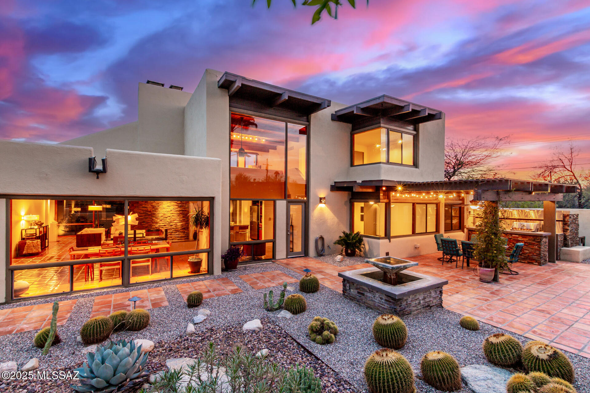 Stunning southwest modernist home by renowned architect David Tyson featuring walls of windows framing breathtaking views. Saltillo tile, soaring wood ceilings, and a stacked stone fireplace enhance the great room. The chef's kitchen boasts SS appliances and ample storage. The expansive first floor includes a primary suite with two-sided fireplace, soaking tub, dual vanities, and large closet, plus two more bedrooms and another bath. Upstairs is a loft with fireplace, views, and an additional bedroom and bath. A second, two-car garage is air conditioned and wired for 110 and 220. The one-acre lot offers privacy with irrigated desert landscaping, multiple patios, pool, spa, outdoor kitchen, fireplace, and stunning mountain views. Owned solar and a prime location complete this dream home. This stunning home embodies the signature style of renowned southwestern contemporary architect David Tyson. Soaring walls of windows on the north and south elevations, along with strategic corner windows, frame breathtaking desert and mountain views. Private patios invite outdoor entertaining, while expansive closets, warm wood ceilings, and rich Saltillo and hand-painted Mexican tiles elevate the home into a true work of art. The most recent owners artists themselvesenhanced this masterpiece with custom lighting and thoughtfully designed built-ins crafted from gorgeous woods.

The spacious main-floor great room blends dining and living areas, anchored by a stacked-stone corner fireplace. In the kitchen, a chef can savor backyard vistas through a massive window wall while prepping at the generous island or cooking on the Thermador professional gas range. Guests can linger at the counter seating, while ample storage and multiple pantries keep essentials tucked away.

The primary suite, with its striking black Saltillo tile flooring, offers a serene retreat featuring a sitting area, private patio, and sweeping views. A two-sided fireplace warms both the bedroom and the jacuzzi tub (equipped with a TV), complemented by dual vanities, a separate shower and toilet, and a large walk-in closet.

Outdoor living shines with a south-facing walled patio, visible from the living area and kitchen, offering filtered shade and five fruiting citrus trees. The north-facing backyardan oasis viewable from most roomsboasts mountain vistas, an outdoor kitchen with covered dining, a gas fireplace, and a sparkling pool and spa with a shaded ramada. Upstairs, a wood-floored loft with fireplace and dual-aspect views, paired with an additional bedroom and bath, creates an ideal guest suite, artist studio, or workspace.

Additional highlights include owned solar for efficiency, a second air-conditioned two-car garage with an air compressor, and a west-side concrete pad. The one-acre-plus lot is adorned with mature cacti, irrigation, and low-voltage lighting, delighting desert aficionados.

One of just eight Tyson-designed homes in the exclusive Paseo de Los Altos enclave, this property benefits from a self-governed HOA (eight households) that maintains the private road, trash, and recycling with bi-annual meetings. Nestled in desirable Casas Adobes, it's minutes from fine dining and shopping3 minutes to Whole Foods, 7 minutes to La Encantada, and 15 minutes to Catalina State Park, the University of Arizona, and Downtown Tucson.

For those seeking a distinctive, artful home in a prime desert setting with easy access to Tucson's best, this is the one.