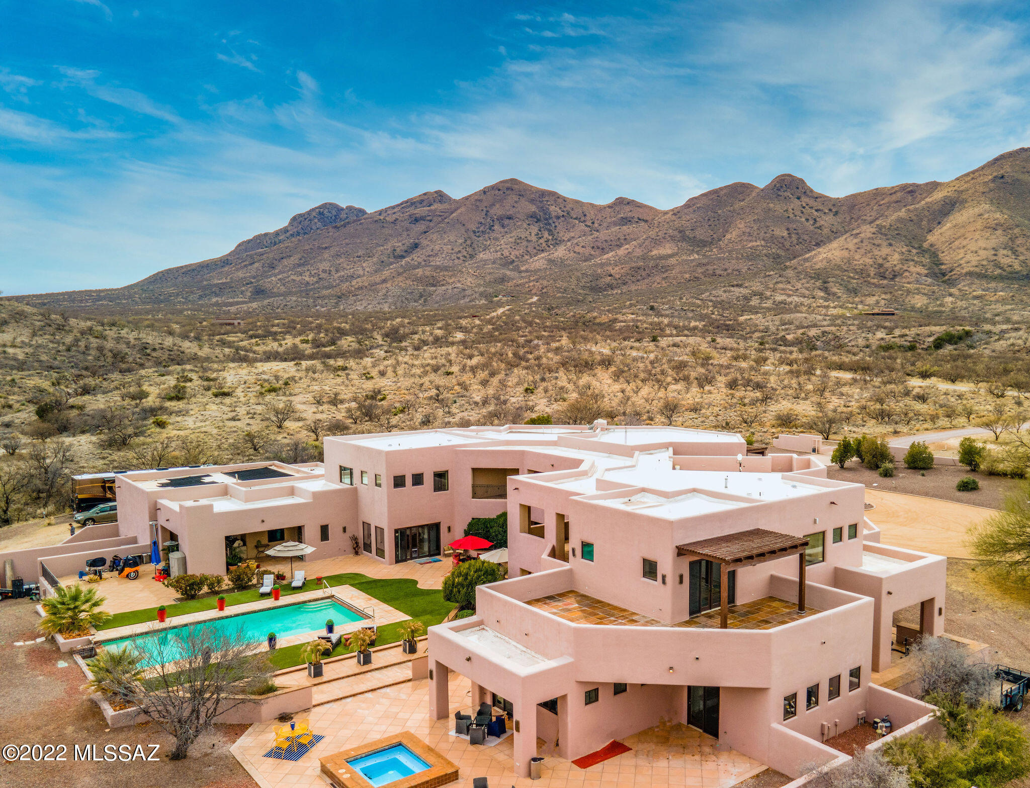 This custom-built home offers 12,800 square feet of luxury living on 72 acres (2 separate, contiguous, 36-acre parcels, allowing a second building site, if desired), four-bedroom suites, and seven bathrooms.  Rastra block construction and commercial grade finishes ensure incomparable quality, insulation, and strength.  This resort-style home is minutes from the arts community of Tubac with its championship golf course, excellent dining, and social gatherings.  Stunning panoramic views of the San Cayetano and Santa Rita mountains are visible from every window, deck, and patio.  You choose your activity - hiking, biking, horseback riding, world class bird watching, reading, entertaining, or simply relax in the saltwater swimming pool (new automatic cover), or oversized hot tub. The Outdoor kitchen with fireplace and overhead heaters for those chilly winter nights offer more than enough space with the adjacent patio to entertain a group of friends or host a wedding.  The entrance foyer presents a spectacular view of the mountains behind the back yard patio and pool.  It also includes a top-of-the-line residential elevator.  The main living area with 23-foot ceilings and walls of windows brings the mountain landscape indoors.  To filter the afternoon sun, shades can be lowered with the push of a button. The living room wet bar is equipped with an ice machine, Subzero fridge, dishwasher, microwave, and Subzero under-counter wine cooler.  The chef's kitchen offers radiant floors, top of the line appliances (most new in 2020), Subzero fridge, two Subzero vegetable drawers, two dishwashers, two microwaves, double oven, ice machine, gas and induction stove tops, as well as a separate butler's pantry with custom cabinets, Subzero freezer, and a 147 bottle, 2-zone Subzero wine fridge.  The executive office suite provides a separate, quiet environment for a home-based business or artist studio. For movie or game night, the theater was built with true theater acoustics and a ceiling with fiber optics that simulate a night sky filled with stars.   It includes a wet bar complete with ice machine, microwave, fridge, dishwasher, sink, and the always popular popcorn machine with space for a pool table.   Upstairs is the large master suite with sitting room, fireplace, radiant floors, his and her 15'x15' closets, separate vanities, steam room, jetted tub, and shower with heat control and full body sprayers.   The oversized garage has walls of custom cabinets, wiring for an EV charging station, and 3 storerooms.  There is space for the largest RV (or two), 50-amp service, and a dump station on the property.   Helicopter?   Set her down in the front yard or install a helipad in one of several flat areas on the property.  A 45K generator, security gate and cameras, two 1000-gallon propane tanks, a producing well that services house and irrigation (local water is available with the turn of a valve, if needed), fire suppression hydrants around the perimeter, and automatic sprinkler system inside provide the back up and security you would expect in a home of this caliber.  Additionally, the whole house smart system allows you to monitor climate (inside and outside), security, pool and hot tub status, and regulate house temperatures and lighting remotely.   If that is not enough, there is a lighted, ventilated tunnel that runs under the entire house providing easy access to the plumbing and electrical systems, elevator equipment and massive storage. This resort style home is truly one of a kind in the heart of the incomparable gated community of Morning Star Ranch.