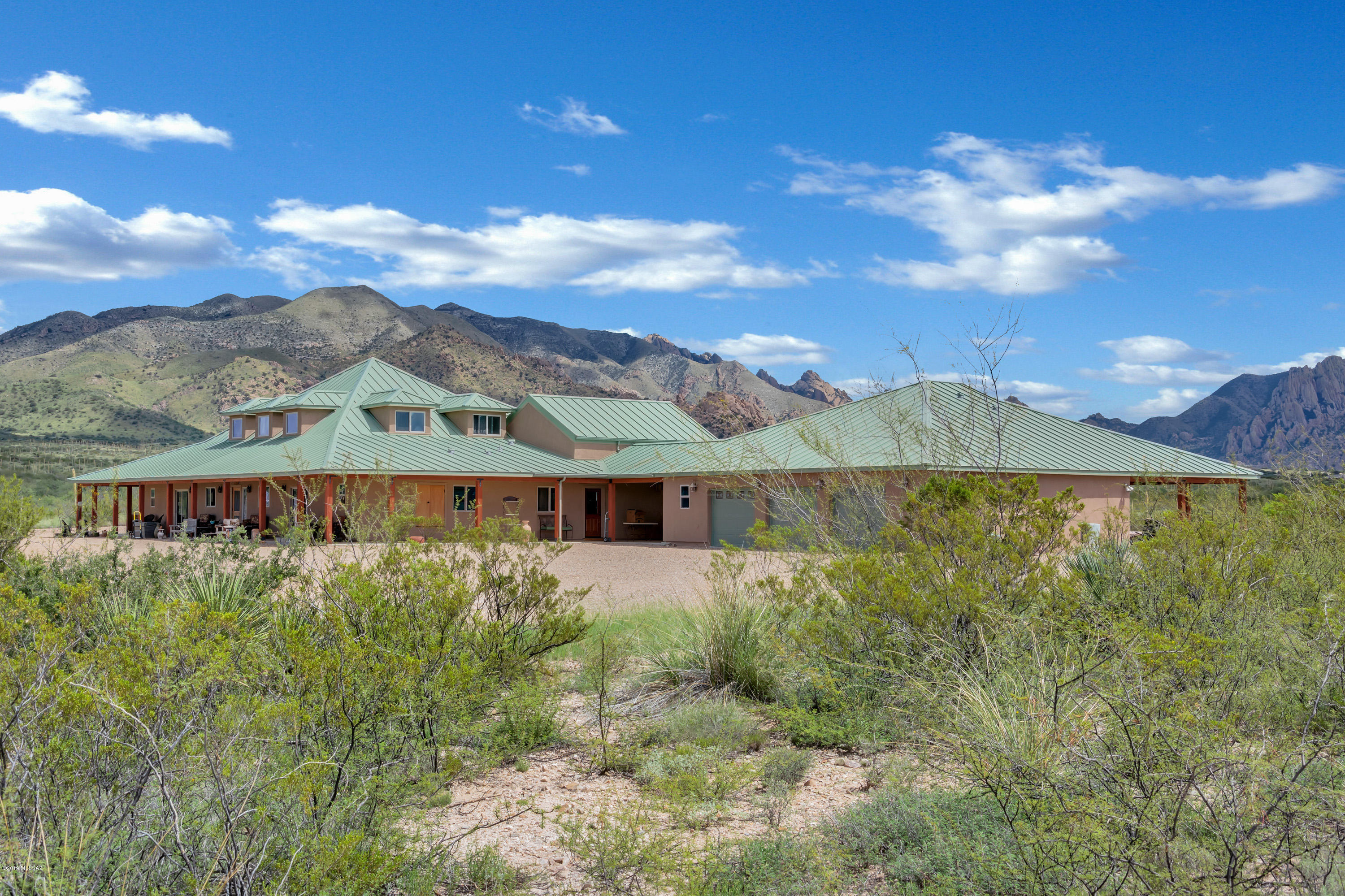 HILLSIDE HAVEN AT BEAR RUN: This is a once-in-a-lifetime opportunity to own a piece of history in a one-of-a-kind property, with the best panoramic views of the Cochise Stronghold. Ownership in Dragoon Mountain Ranch provides the opportunity of rural living while only living 25 minutes to shopping in Benson, AZ. This 36-acre parcel has its own 455-foot water well that pumps 10 gallons a minute with a 5,000-gallon holding tank.For the work at home owner, this property offers high speed fiber optic internet access and for the owner with a green thumb nine fruit trees plus nine spacious planting beds, all on drip irrigation and a greenhouse to grow your own vegetables which adds to the delight of harvesting your own delicious treats.This is a premium location because the property sits ...... HILLSIDE HAVEN AT BEAR RUN: This is a once-in-a-lifetime opportunity to own a piece of history in a one-of-a-kind property, with the best panoramic views of the Cochise Stronghold. Ownership in Dragoon Mountain Ranch provides the opportunity of rural living while only living 25 minutes to shopping in Benson, AZ. This 36-acre parcel has its own 455-foot water well that pumps 10 gallons a minute with a 5,000-gallon holding tank. For the work at home owner, this property offers high speed fiber optic internet access and for the owner with a green thumb nine fruit trees plus nine spacious planting beds, all on drip irrigation and a greenhouse to grow your own vegetables which adds to the delight of harvesting your own delicious treats. This is a premium location because the property sits high on the ridge line and provides the best panoramic views around with access to the Coronado National Forest with it's own private entry gate to the Cochise Stronghold for hiking and horseback riding. The great room has a story book window that frames the views of the Cochise Stronghold as do the picture window and patio in the guest house. The upgrades are extensive, including granite countertops, lifetime standing-seam metal roof, three dishwashers, GE profile appliances and four fireplaces surrounds. The property has too many details to list in the attached documents.This is a special property, and one that cannot be duplicated at this price. Come on out and see it and you may catch me out for my daily walk on over 50 miles of peaceful easy tranquil roads where I spend my evenings interacting with all our beautiful creatures living at 4864 feet above sea level in the  Chihuahuan desert just 7 miles East of Benson.