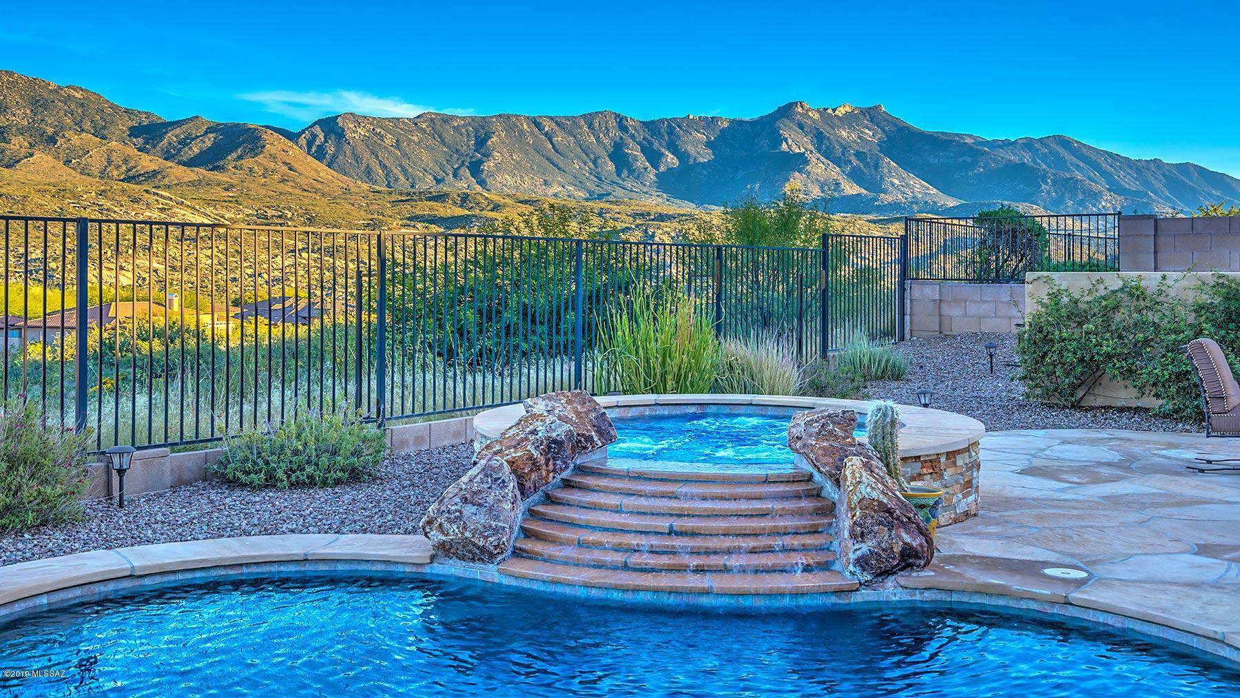 Sited on private, elevated lot in the desirable Preserve this elegant Sonoran is perfect for enjoying the magnificent unobstructed mountain views. Pride of ownership abounds w/over $300,000 in customized upgrades. A wall of windows in the great room overlooks the pool, views, custom entertainment center & gas fireplace. Gourmet island kitchen w/stainless appliances, gas cooktop, granite counters & designer lighting. Spacious master suite w/bay window opens to private patio. Master bath w/double sided walk-in shower, soaking tub, dual executive height vanities & customized walk-in closet. Den w/custom built-ins, guest suite + separate casita. Solar heated pebble tec pool w/hand tiled spa & waterfall, porcelain tile & plantation shutters throughout, + 3 car garage w/plenty of storage