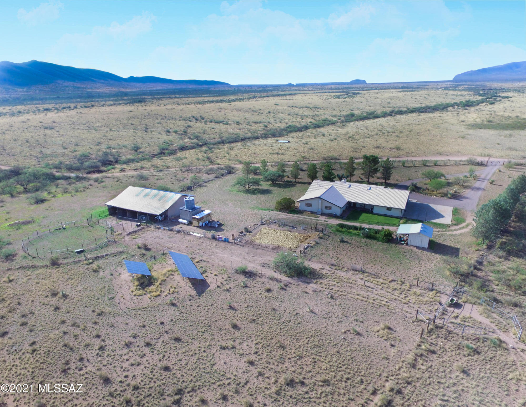 Equestrian & independent life with no HOA limitations! Solar rammed-earth, custom home AND barn/shop on 60-acres. Move-in ready. Owned-solar system/backup generator, excellent well. Private, off-grid. Easy 11 miles to historic Tombstone AZ. HOUSE: 2,680SF rammed-earth 2-ft deep, insulated walls comprise main living area 4-BR, 2-1/2BA, laundry, dining, kitchen w/ Wolf range-oven, living room, w/stone fireplace. Actually 4,400SF under-steel-roof spans attached 2-car garage, storage, 2 porches and office/5th BR. Saltillo floors, solid white-oak cabinetry. AND milled timber & steel 2,880SF BARN SHOP 3 horse stalls, saddling/hay storage, tack room, workshop, oversized doors. RV space. Gardens, lawns, mature trees, more! Ride-out from property. Fenced & cross-fenced 60-ACRES--CAN BE SPLIT/BUILD!