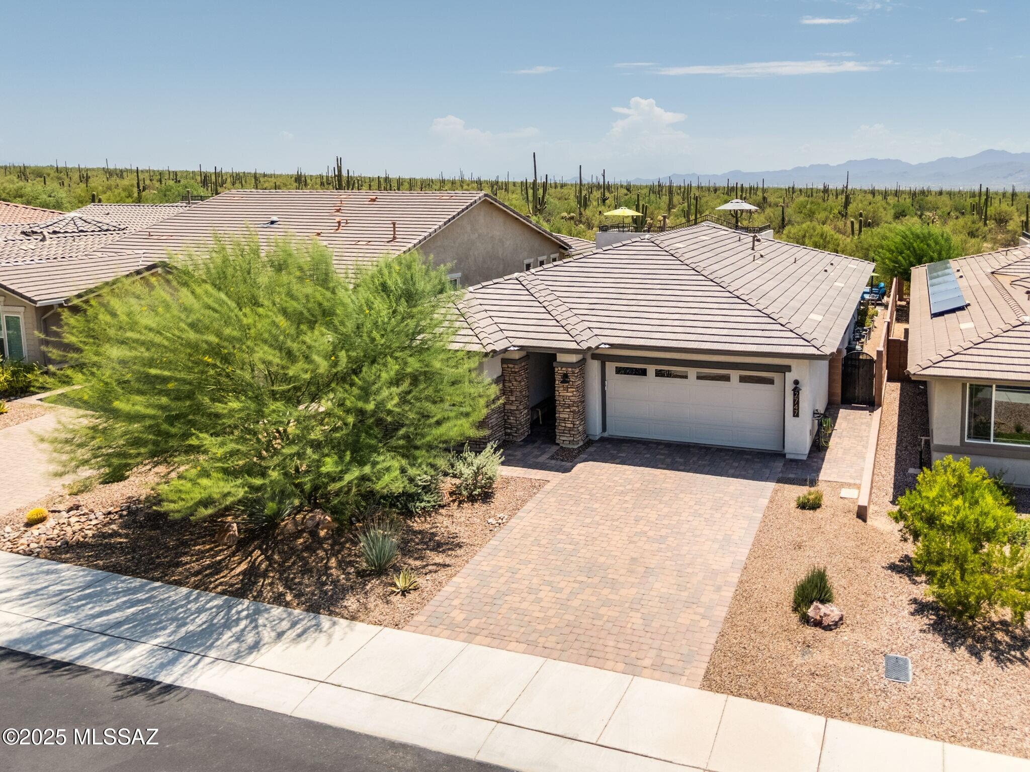 Discover the perfect blend of style and comfort in this gorgeous, newer 2BD/2BA +Den (1,797 sq ft) home in gated Blue Agave. Backing to wide open space, this contemporary home boasts a resort-style yard with spectacular desert, valley and mountain vistas. Luxurious open concept, split bedroom plan is complemented by recessed ceilings, overheight doors, neutral décor with decorator accents, indoor/outdoor wired sound, plus Quartz countertops and Porcelain plank tile throughout. Sleek gourmet kitchen hosts island with breakfast bar, stainless in-wall ovens, gas cooktop and wine fridge, plus custom pantry. Spacious living area is highlighted by triple, retractable sliding glass doors to effortlessly meld indoor/outdoor living. Elegant Primary suite accesses rear patio while hosting a luxury spa bath with soaking tub, walk-in shower, dual sink vanity and custom walk-in closet. Front Guest room adjoins hall bath and spacious Den with glass paneled entry. Spectacular rear oasis is complemented by an extended Travertine patio flowing to an oversize heated pool with triple fountains, sun shelf, raised spa and linear fire pit. You'll also enjoy an outer dining patio and winding staircase to large view deck with breathtaking, panoramic views. Extended, epoxy coated 2-car garage with water softener and overhead storage racks. Dove Mountain is home to the Ritz-Carlton Resort, world-class golf, assorted parks, hiking/biking trails and nearby amenities. Perfect for the most discerning buyer!