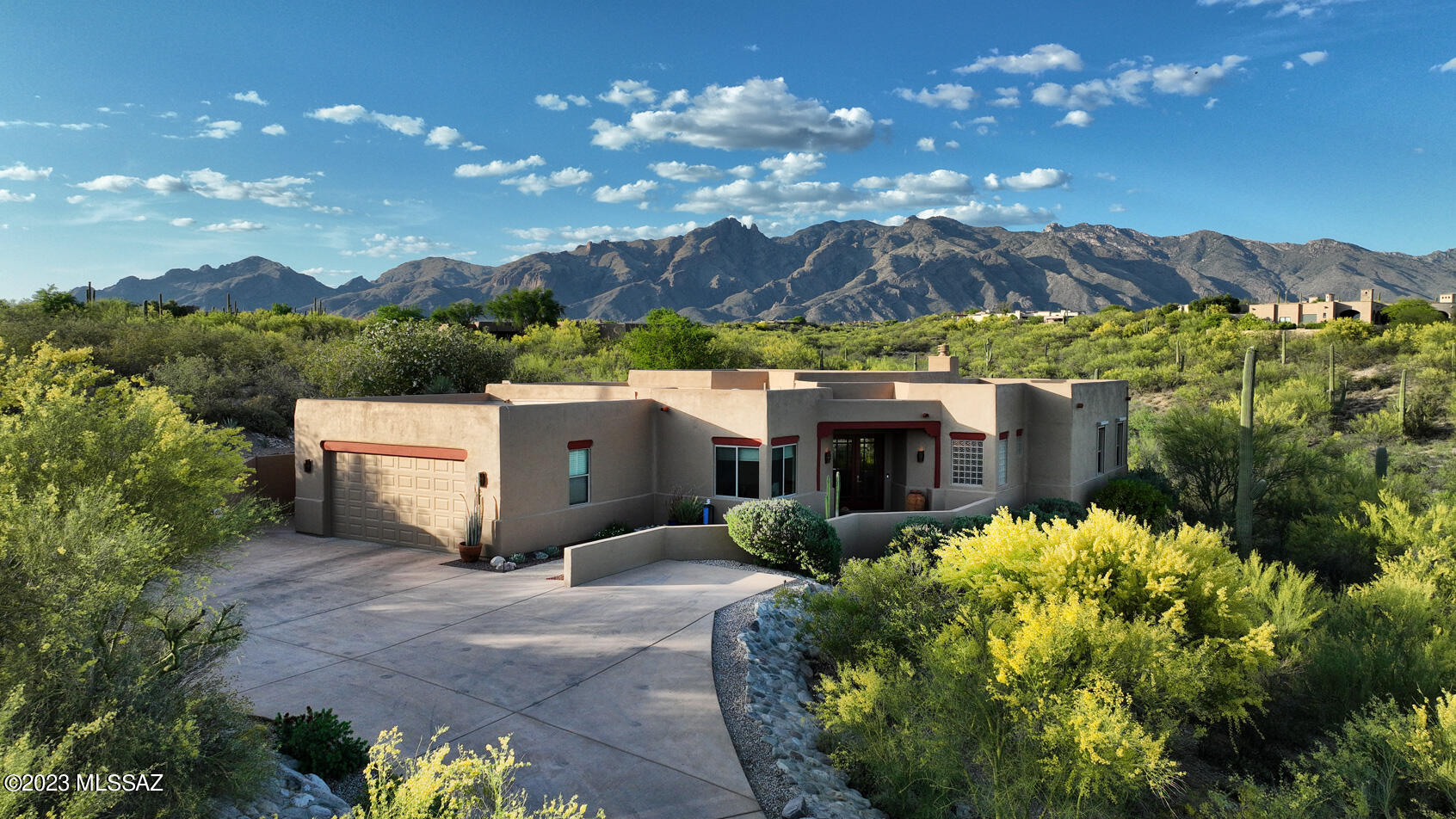 Dramatic long driveway leads you to this pristine custom home with full unobstructed views of the Catalina Mountains. Located on a rare 2 acre lot surrounded by natural desert. This fine home offers the convenience of an open floorplan, huge windows, multiple patios, high ceilings and a fully remodeled primary bath with no step shower. Beautiful tile throughout. Granite and stainless kitchen with newer appliances. Recent HVAC and water heater. Stunning water feature and specimen plantings with remote controlled rolling window screens. Wonderful gated central Foothills community is so convenient all of Tucson and the Foothills.  Did I mention the views!!