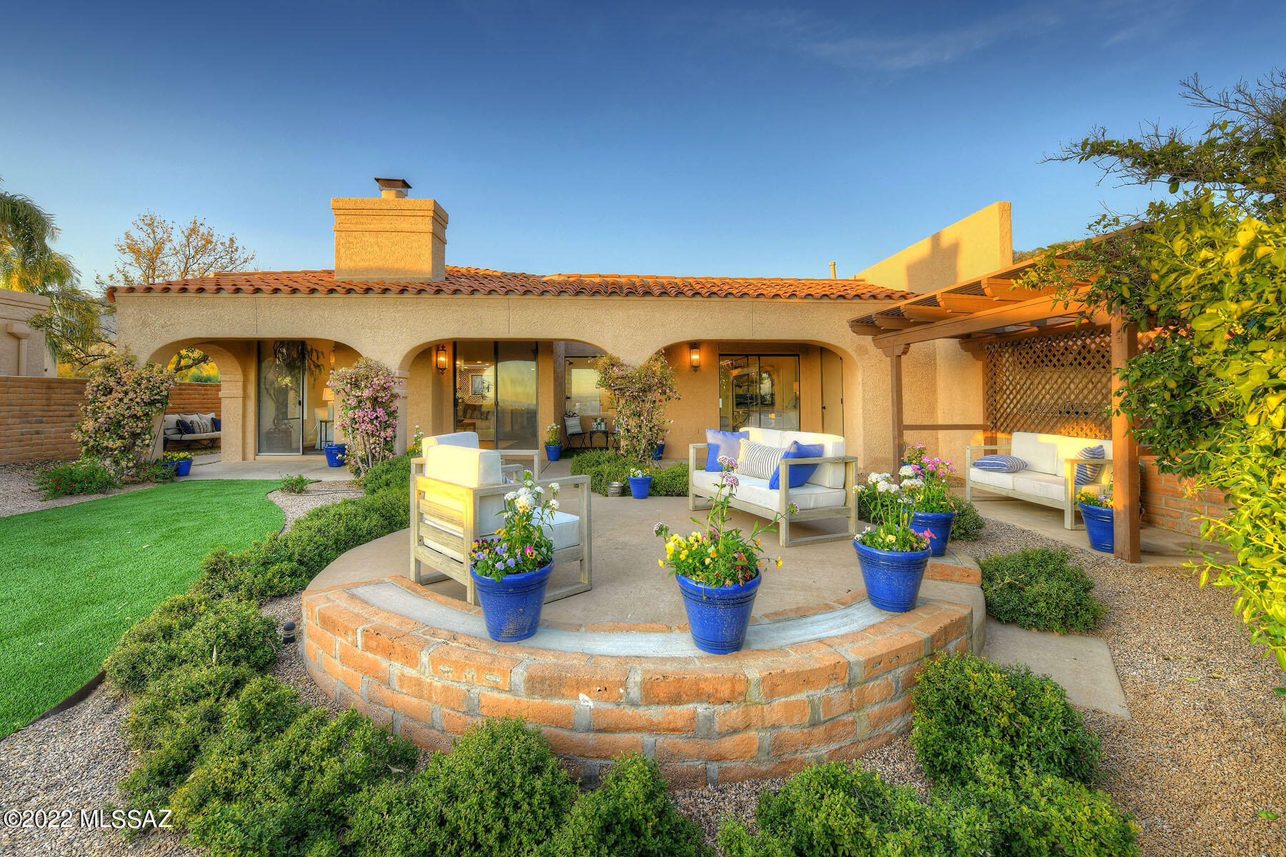 There is nothing like entering a home and being greeted by endless city views, a light & airy ambiance, and patios at every turn.  Warm wood floors , whisper white, and accented by hints of slate blue. Sounds funny, but a feeling of Nantucket meets Tucson.  It works!. Officially  a 3 bedroom but 1 makes the perfect office or den. Picture a gourmet kitchen with  unique (but fun) tile accents and an island that is perfect for helping the chef...  or better yet having, a glass of wine or that first cup of coffee.  The front courtyard with its Bistro table is a great spot for views of the Catalinas.  The back? Quite simply, there is nothing not to like.