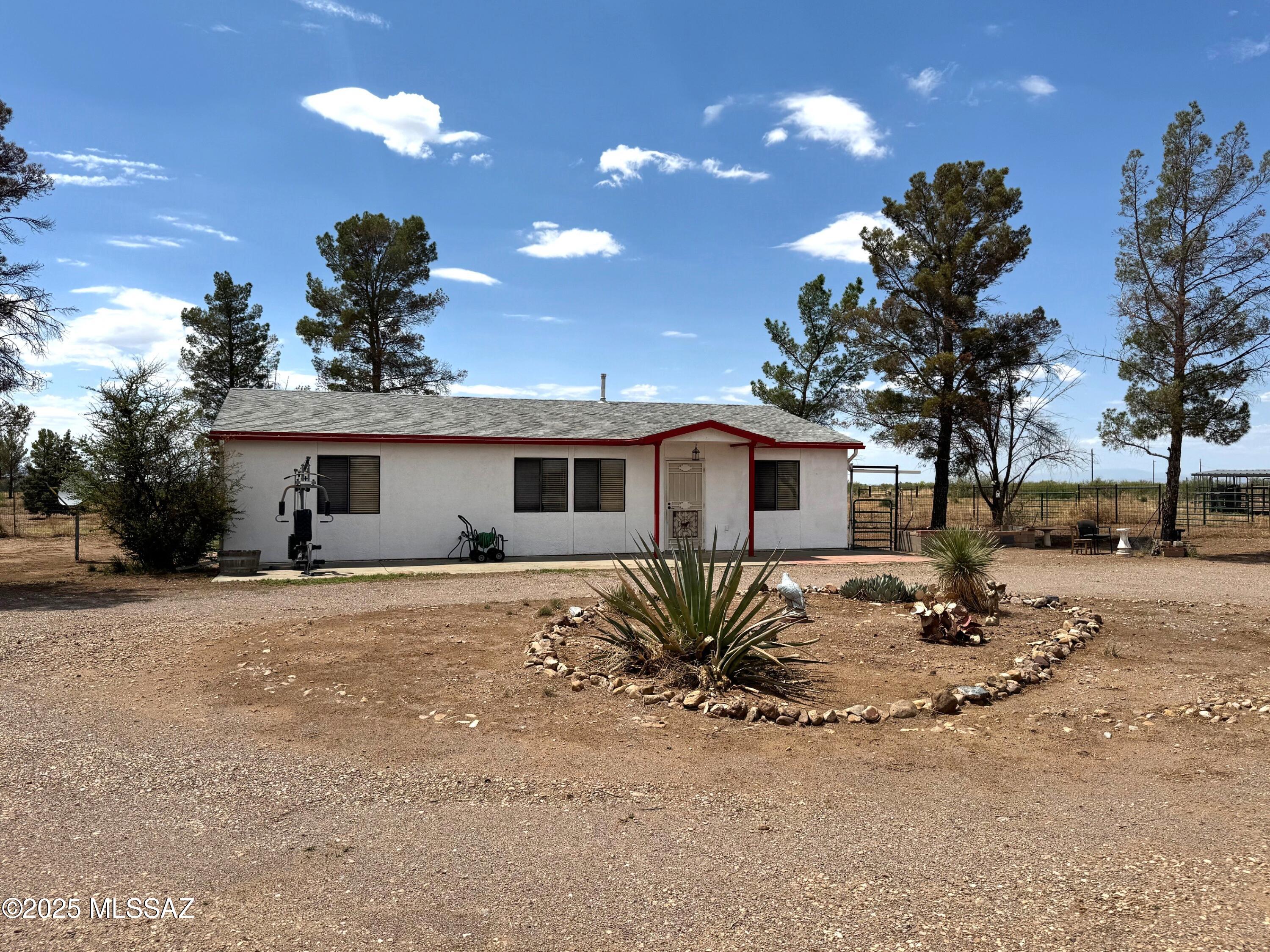 GREAT HORSE Property spread over 8.5 acres, fenced and crossed fenced with no climb fencing and a 4 stall mare motel, tack room and extra outbuilding with porch for either a workshop or whatever you want. Also an additional out building that had been used to house goats. Bring your animals to this spacious property. It includes a beautiful 3 BR, 2BA open floor plan home with ceramic tile throughout, very light and bright! A newer heating and cooling system was installed 06/2021, dual pane windows, a 30x40 metal garage/workshop/barn with elec & water, RV hookup for your traveling friends, Sale will include washer, dryer and refrigerator. This is a place for happy animals & happy people! Quality country living at it's best that includes amazing 360 degree views.