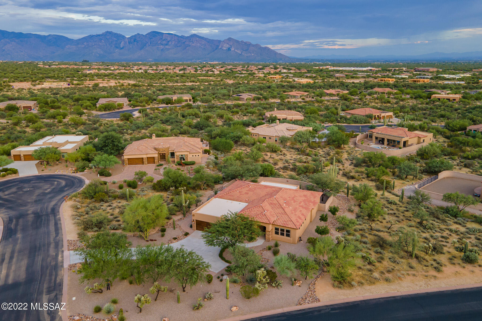 Enjoy views of the Catalina Mountains from the large spacious yard! Welcome to a like-new and luxurious A.F. Sterling home in Tortolita Vistas, a private gated community near Dove Mountain, where all lots are over ¾ Acre. While the homes are very private, it's a friendly community where homeowners know and trust each other and have occasional neighborhood gatherings.  The handsomely landscaped front yard leads to a charming front porch area and an elegant double entry door of iron with set-in screen features, providing an opportunity for cross-breezes on our cooler days and setting the stage for this beautiful home. A coffered ceiling accentuates the entryway and views across the great room of the lush Sonoran Desert beyond the home. A spacious den/office/TV room is adjacent to the entry. With a popular open floor plan showcasing large spaces, the dining room can hold a table adequate for "friends and family", while the great room is also comfortable for relaxing or entertaining. The ample breakfast room is adjacent to the breakfast bar, providing a plethora of seating options and access to the rear patio and yard. A well planned kitchen features granite counters and handsome wood cabinetry with pull-out features for easy access. The pantry also has pull-out shelving. A five-burner gas cooktop and wall oven provide excellent cooking options, along with the outdoor kitchen built-in barbecue nearby. The gas cooktop is accented with a tiled custom scenic backdrop, and subway-style tiles provide a stylish backsplash throughout the kitchen. An island provides additional storage. The nearby laundry room is large, with built-in cabinetry for storage of laundry/cleaning supplies (note the newer Samsung washer/dryer, included). The home is a split floor plan, providing three smaller bedrooms and two full baths on one side, including one bedroom with an en-suite bath. The expansive master bedroom enjoys views of the Catalina Mountains and has another handsome iron door to the outdoor covered patio, with plenty of room for a large reading chair. A spacious walk-in closet plus another smaller closet outfitted with cubbies (by California Closets) provides significant space for clothing and sundries. The primary bath has double sinks separated by a seated make-up counter, a separate WC, and a large walk-in shower with double shower heads. The rear yard encompasses a well-sized (extended) covered patio, an outdoor kitchen with a built-in barbecue, and room to add a pool while enjoying views of the Catalina Mountains and desert greenery in a private setting. The large 3-car garage includes upgraded garage doors and epoxy-finished floors. This like-new home is spotless, perfectly maintained and move-in ready for you. All services, groceries, and other needs, and restaurants are nearby, with quick access to both Oro Valley and I-10 for downtown Tucson and Phoenix. Furnishings may be available on a separate bill of sale. We look forward to showing you this lovely home at your earliest convenience.