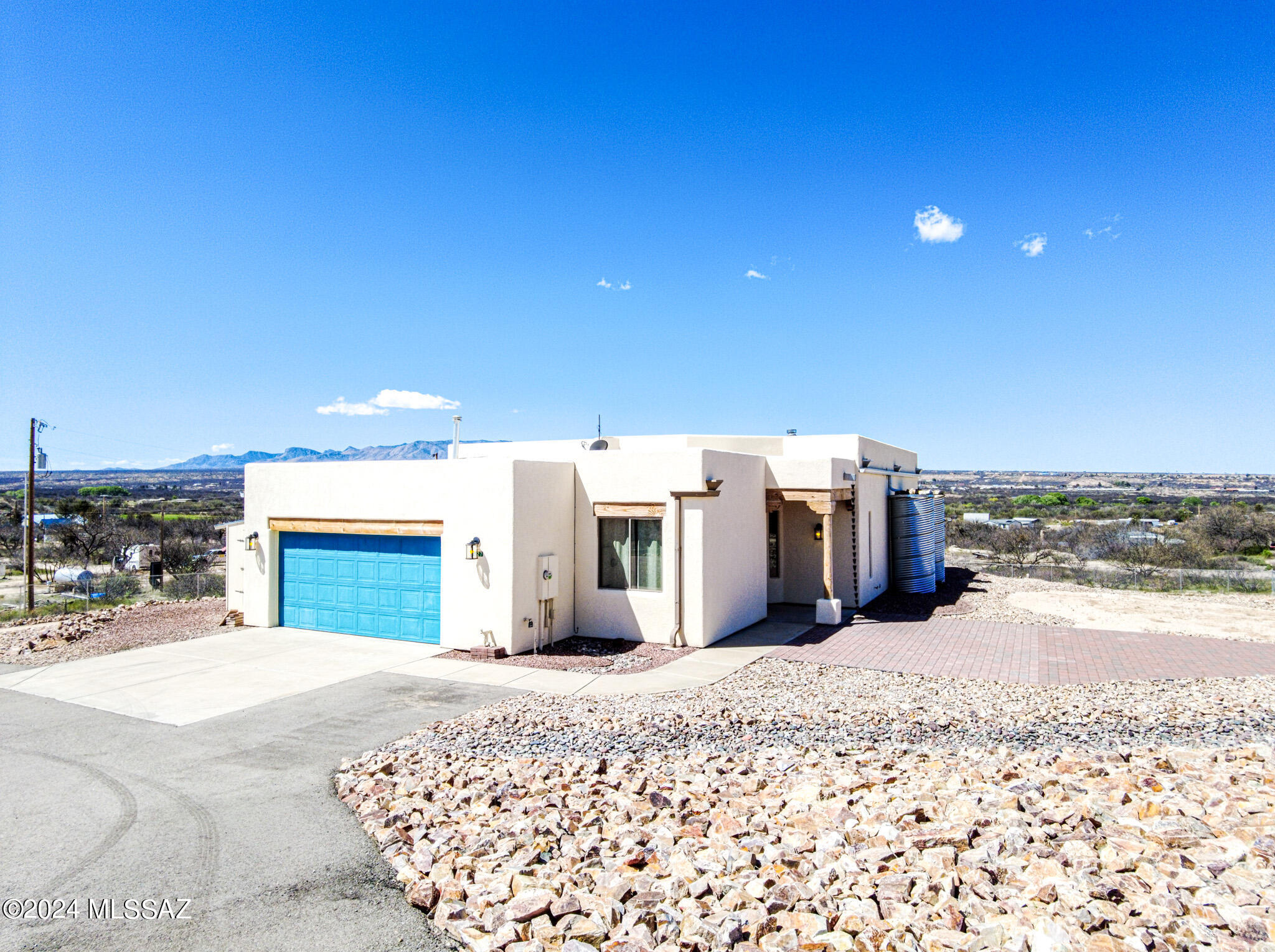 GORGEOUS HOME WITH FABULOUS HILLTOP VIEWS!  3 BDRM/2Ba with charming wood fireplace in Living room/Great room. Stainless steel appliances in well equipped kitchen. Stunning ceramic tile counter tops in kitchen, bathrooms and shower/tub surrounds. Covered back patio w/decorative metal fencing, rock landscaping for easy care and entire acre has 6' chain link fencing. Oversized 2 car garage & shed.