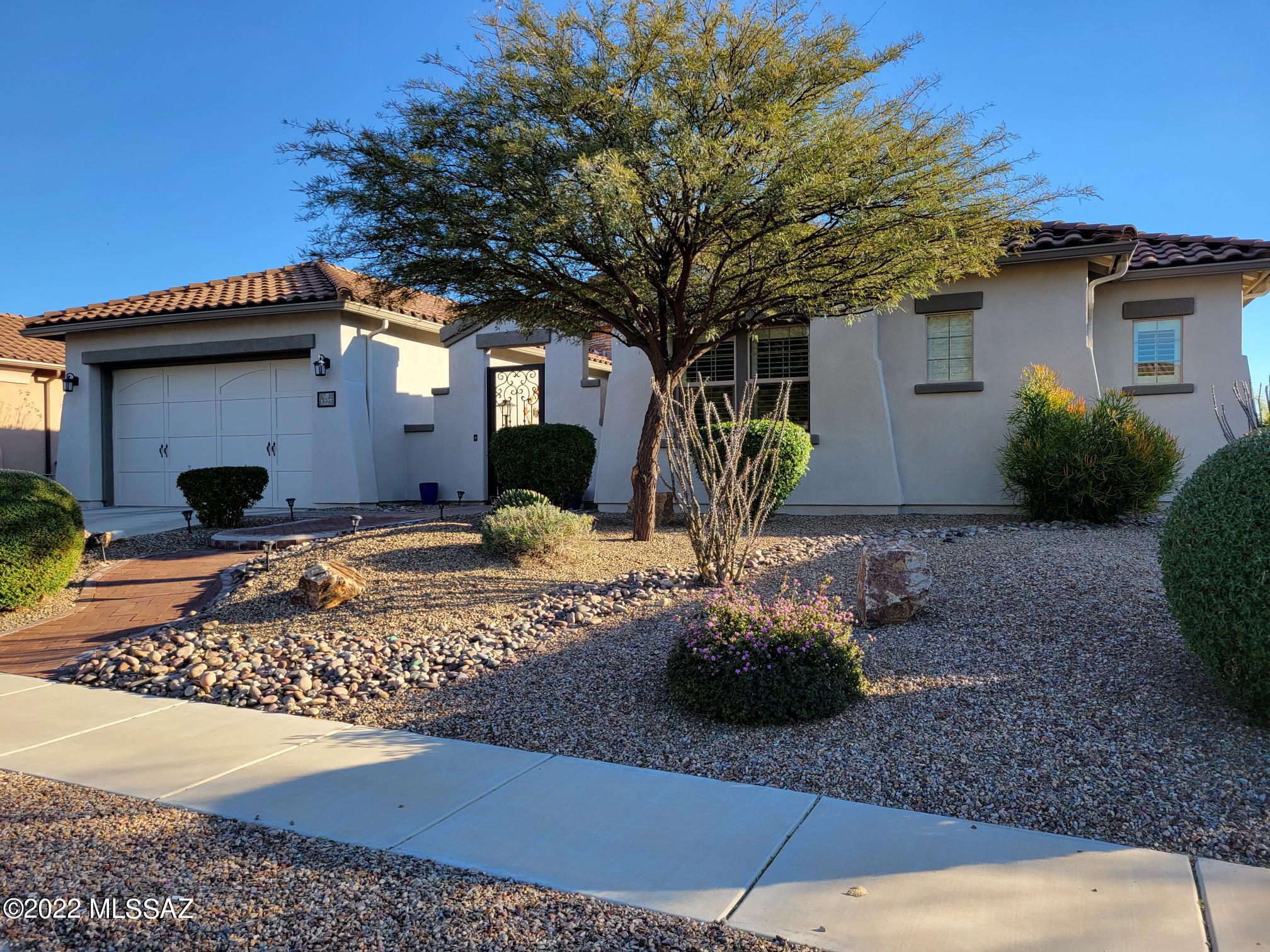 Spectacular, highly updated 4BD/3.5BA (3,076 sq ft) home resides on a cul-de-sac lot in the gated Siena community at Rancho Vistoso. Gated, brick paver courtyard flows to stacked stone turretted entry. Classic 18'' tile w/black diamond granite inserts, luxury wood laminate flooring in bedrooms plus shutters throughout. Enjoy formal living & dining rooms plus Great room w/soaring ceilings & fireplace. Large Chef's kitchen w/breakfast nook boasts granite counters & newer SS Dacor appliances w/double ovens. Elegant Master suite hosts bay window, soaking tub, walk-in shower, dual walk-in closets. 3-car tandem garage has 2-foot extension. Surround sound inside & out. Resort worthy yard boasts a covered patio, firepit patio, gated Pebble Tec pool w/cascading water features plus Catalina views!