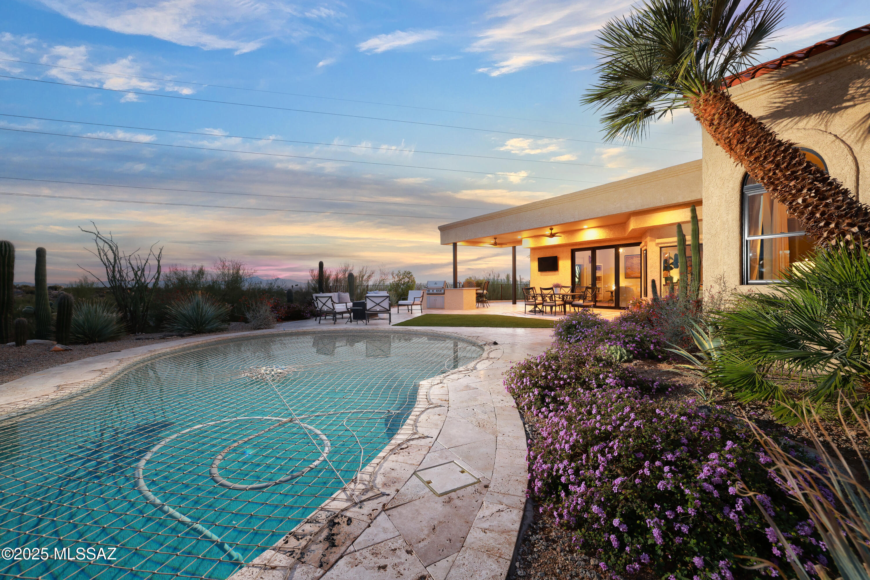 Perched on a high ridge near the top of Campbell with unbelievable panoramic views of the city lights and the mountains surrounding Tucson. A long private drive climbs from the quiet cul-de-sac to the home. 100% completely remodeled inside and out with nearly every surface renewed. Some design elements by Marc Soloway. Landscape design by Shelly Ann Abbot. New kitchen, new baths, new Pella doors, new porcelain tile throughout, newer HVAC, newly surfaced pool...check the attached improvement list for more.  The primary suite features custom vanities with built-in outlets in drawers and an oversized walk-in shower with mosaic tile. The spacious yard features a wrap-around covered patio, built-in BBQ with granite countertops, and expanse of travertine decking & patios.