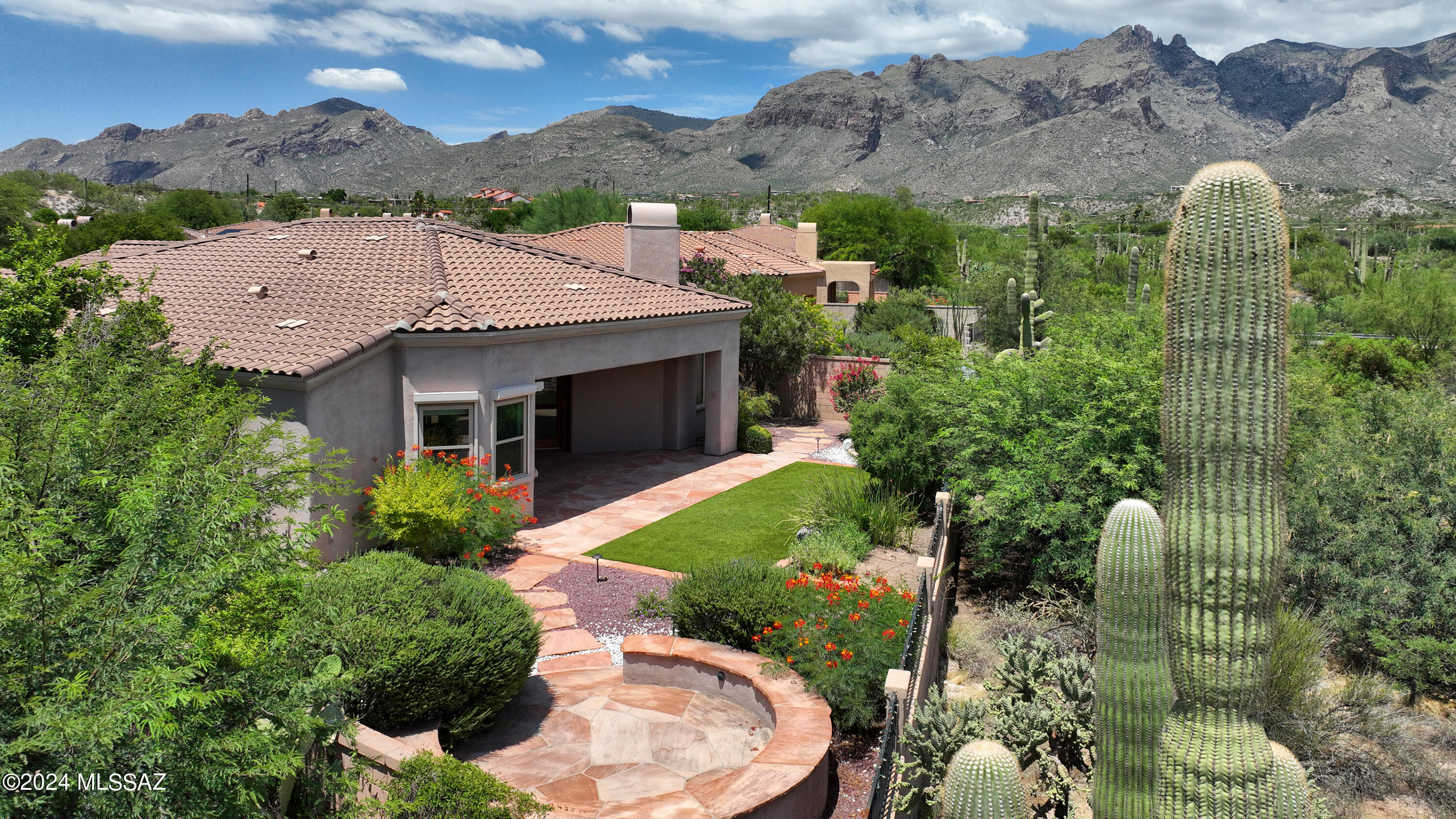 Hard to find, stunning, 1 level home with 4 bedroom/ 3 full baths and 3 car garage in guard gated La Paloma. Incredible premium lot with gorgeous photo worthy views, that borders a large natural common area studded with majestic Saguaro's. Spacious rooms, tile floors and high ceilings throughout. Primary features a sitting area and double closets. Freshly painted inside with new appliances and carpet in the bedrooms. 4th bedroom has built in desk and bookcase, currently used as a den. Large professionally landscaped yard with covered porch, turf grass, fountain, flagstone and mature fruit trees. Even a car charger in the garage. Close to the sparkling community pool & spa. HOA fees include; guarded gate, trash pick-up, front yard maintenance and community pool/ spa.