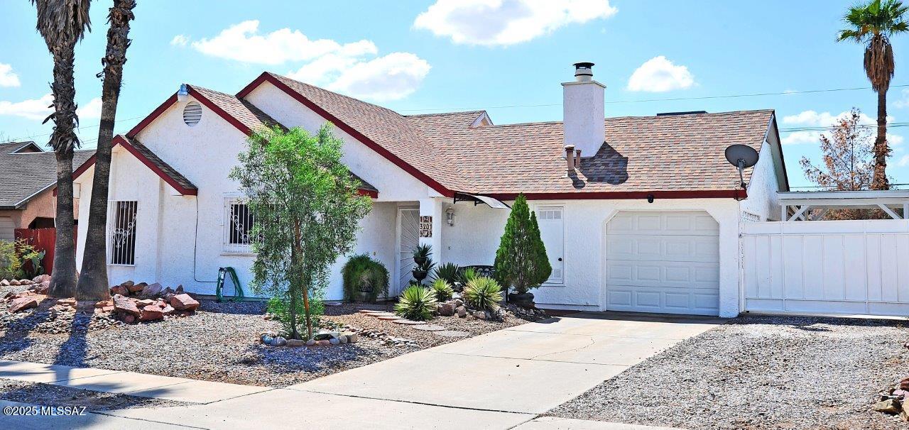 3 bedroom/2 bath with all tile and no carpet!  Well maintained home with large covered rear patio and a big yard with stucco block wall and mountain views!   Nice size kitchen with all the appliances including a new microwave.  Great room off the kitchen with fireplace and dining area.  AC and furnace only 2 years old.  1 car garage plus a one car carport.  2 sheds in the back also stay.  Come by and see this lovingly well cared for home!