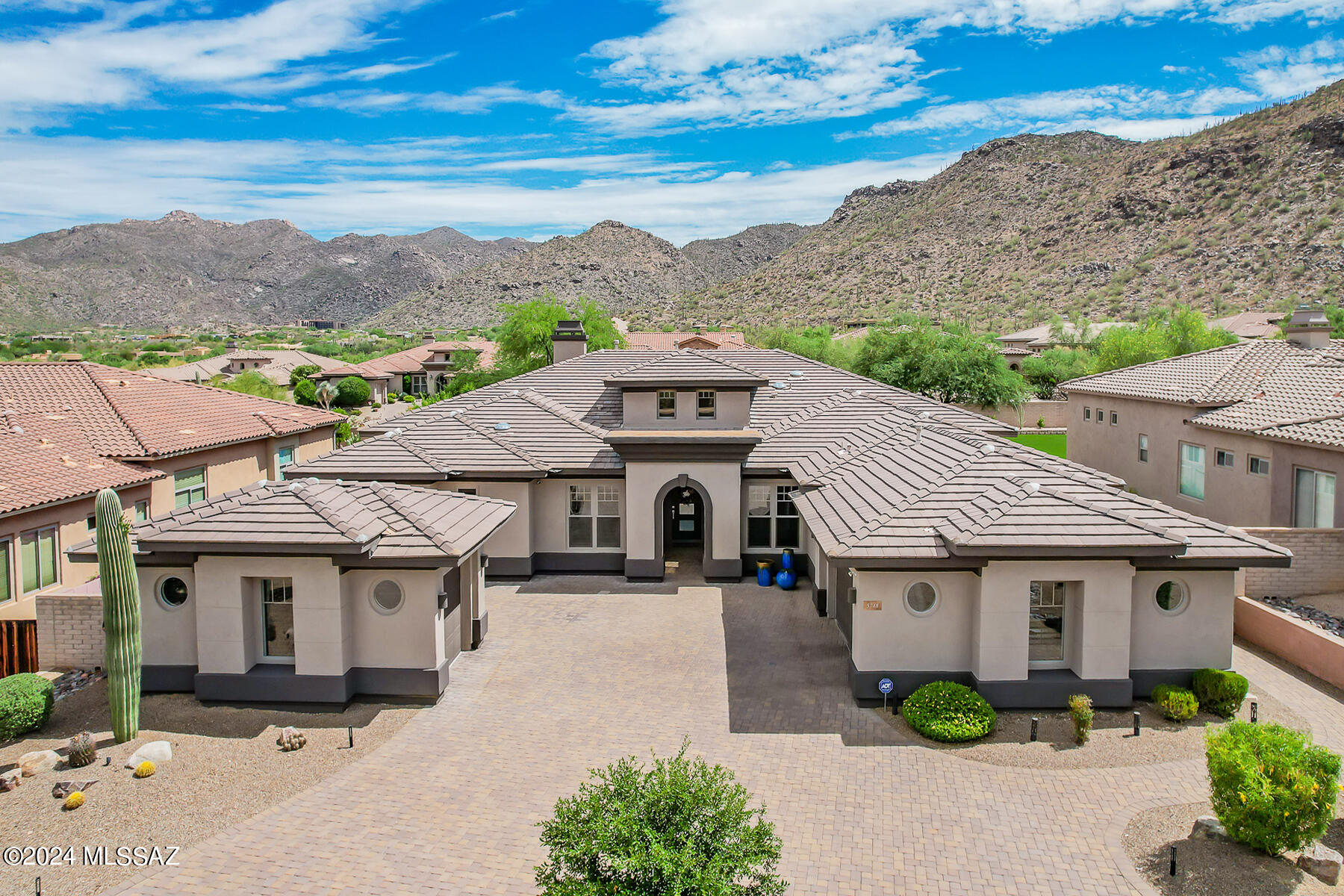 Spectacular, luxurious 3BD/3.5BA (4,030 sq ft) Toll Brothers home at The Fairways in gated Solana has been recently updated and refreshed. Situated between the world class Ritz-Carlton Resort, Golf Club at Dove Mountain and Gallery Golf & Sports Club, this exquisite estate affords exemplary resort-style living while stunning architectural detail evokes an understated elegance with contemporary flair. Greeted by a circular brick paver drive, enter to find a turreted Grand foyer with decorative inlaid tile, soaring clerestory windows and a tray ceiling with suspended chandelier. Beyond lies an expansive Gathering room ideal for entertaining and highlighted by soaring ceilings, oversized tile floors, wall-to-wall view windows and sliding glass doors, walk-in wet bar with granite counters and new sink, updated linear gas fireplace with floor-to-ceiling stacked stone surround, central media wall with sitting area, plus an elegant, circular dining room displaying a tray ceiling with suspended chandelier and 5 tall, curved windows overlooking the Tortolita mountains and sparkling pool. Sleek gourmet kitchen with breakfast bar, dining nook and walk-in pantry boasts an updated center island with quartz waterfall-edge countertop, quartz countertops with tiled backsplash, plus all new suite of higher end KitchenAid appliances including commercial grade 6-burner gas cooktop, stainless steel double wall ovens, microwave, dishwasher and triple door refrigerator/freezer. Left wing of home affords a Den/Office with French doors and wood plank flooring plus an impressive Owner's suite with patio access, expansive tray ceiling, linear fireplace with custom stone surround and dual walk-in closets. Luxurious, spa-like bath hosts dual granite-top vanities, relaxing jetted tub with new tile surround plus coordinating tiled walk-in shower and a make-up counter. Right wing hosts two en suite Guest rooms with updated vanities plus large, open Den/Media room for relaxation and entertainment. Interior/exterior of home and garages have been repainted (some closets excluded). Additional amenities include new entry door with frosted glass panels, laundry room with sink and new countertop, updated powder room with floating vanity sink, tiled main areas with new carpet overlay in bedrooms, wood shutters, central vacuum, water softener, dual-line reverse osmosis, zoned heating & cooling, alarm system, attached 2-car garage and 1-car detached garage with epoxy coated floors. Retreat to an expansive resort-style rear yard boasting a covered patio with triple entry, raised paver patio with updated fire pit (new fire ring and blue cut stone), BBQ island with sink and new grill, oversized heated pool with raised spa and repainted pool deck, decorative turf lawn, new landscaping and LED lighting plus added irrigation lines, block privacy wall and Tortolita Mountain views. Perfect for the most discerning buyer!