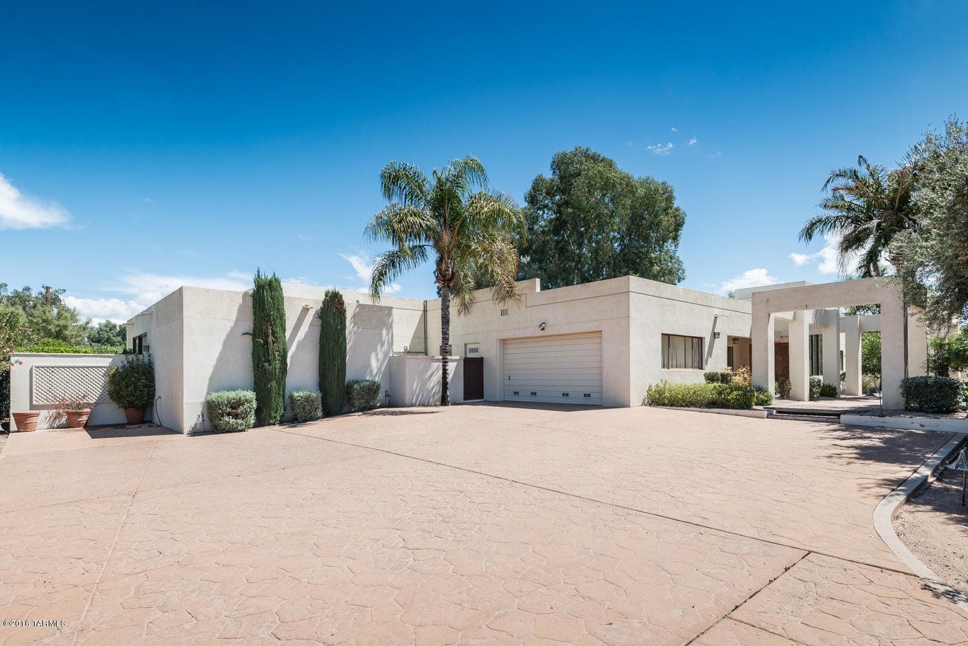 Splashing fountains, custom lighting, and carefully chosen indigenous plantings for our sunny arid climate. Tucked away by the high walled patio is a beautiful contemporary home, the natural light with walls of windows, fire place and views of the north and south patios is a fabulous great room. The master suite has a fireplace, two huge closets, private patio, and spacious storage room. Split bedroom plan has another master suite, bedroom, and office. Outside has a beautiful patio, lap pool, gorgeous shade, with tennis court. Perfect home for entertaining and room for a guest house.