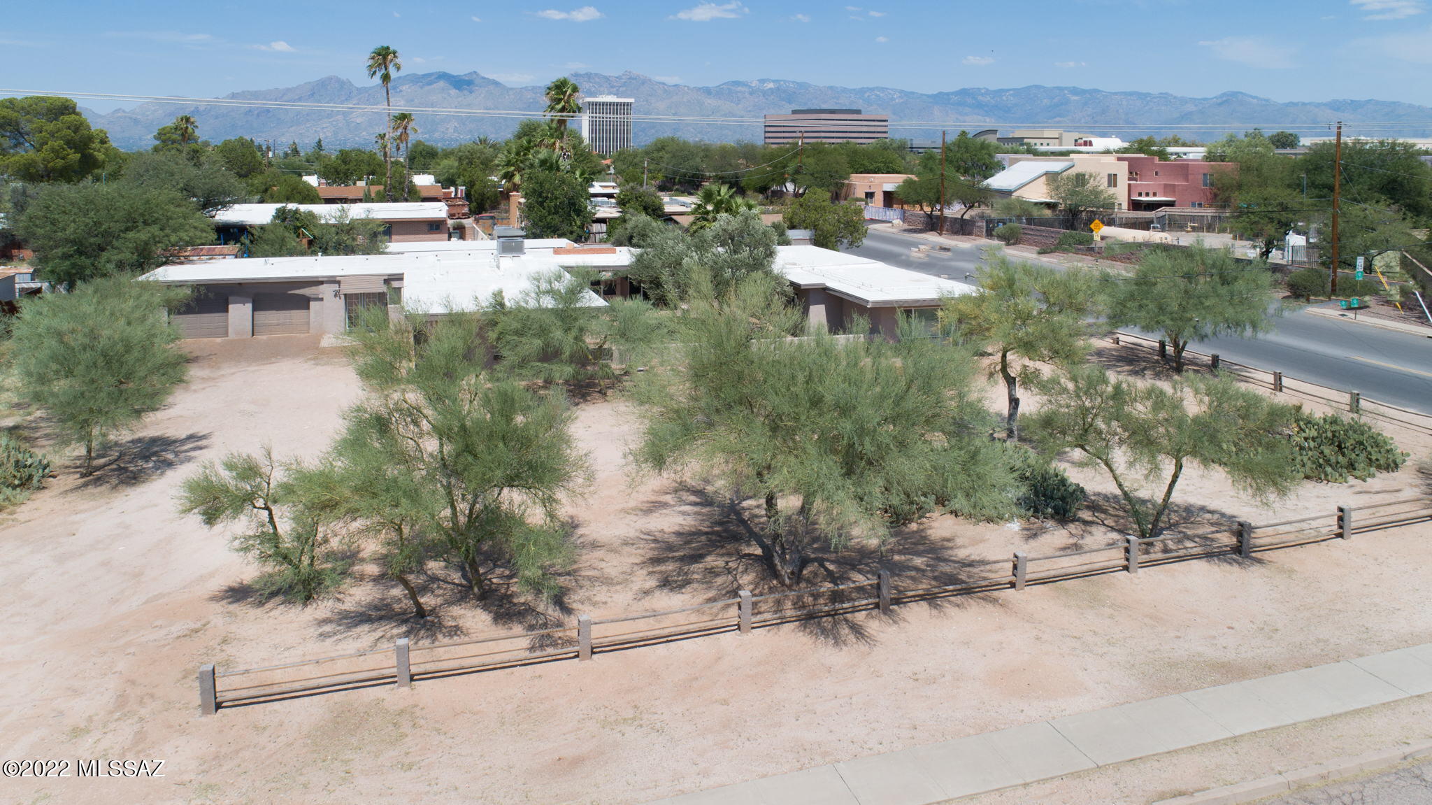 DON'T MISS OUT ON THIS INCREDIBLE OPPORTUNITY!

This Beautiful Investment Property provides steady income with potential for increase, and is located in central Tucson on a large .624 AC Corner Lot with ample room for parking and expansion. 

This Updated 3,144 SqFt Open Split-Bedroom Floor Plan offers stained concrete flooring throughout the main living space and hallways, 5 Large Bedrooms that can accommodate double occupancy, and 2 Bathrooms w/ walk-in shower. The expansive Great Room is perfectly suited for large gatherings, and boasts a wood beam ceiling w/ 2 lighted ceiling fans, stained concrete flooring, and an impressive wood burning fire place with large mantle. Adjoining the Great Room and Kitchen is the sizable Dining Area with wood beam ceiling, lighted fan, and a large window wall that provides lots of natural light, and offers access to the back patio. The spacious open kitchen is appointed with granite countertops, lots of cupboard space, gas stove, microwave, dishwasher, double-bowl sink, and more. Located off of the kitchen is the East Hallway, which provides backyard access and houses 2 Bedrooms, large linen closet, and a Bathroom that adjoins the Laundry Room w/ washer & dryer hook up, utility sink, and linen/storage closet. The West Hallway located off of the Great Room also provides backyard access, 2 Bedrooms, and an XL Bathroom w/ double vanity. The 5th Bedroom is adjacent to the Great Room and provides access to the Extended 2 Car Garage w/ drive-through capability. In addition, the property also offers an oversized 2 Car Carport with attached storage room. 

The enclosed Back yard is sure to please, as it boasts an expansive flagstone patio with large wood burning fireplace, and overhang that provides ample shade. 

Some additional features that provide value include 2 HVAC Units and 3 Hot Water Heaters installed in 2020, New Roof Installed 2020, Double-Pane Windows throughout, Wrought-Iron Security Doors, updated Kitchen and Bathrooms, and Lighted Ceiling fans in all rooms.