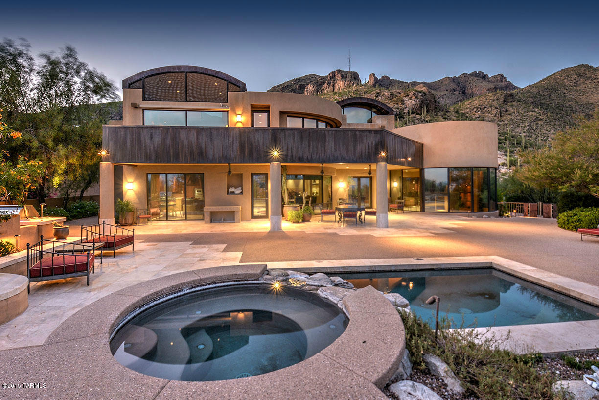 Fabulous Contemporary home with 24 foot soaring ceilings, travertine flooring thru-out. 3 bedrooms including wonderful master suite with his and her bath and closets plus exercise room.  Chef's kitchen with top of the line appliances, granite counters and large island.  Enjoy movies in private home theatre.  Outdoor living at its best with pool, spa, several covered patios, putting green, 4 car garage all on 3.3 acres in prestigious guarded community surrounded by the Catalina Mountains and twinkling city lights.