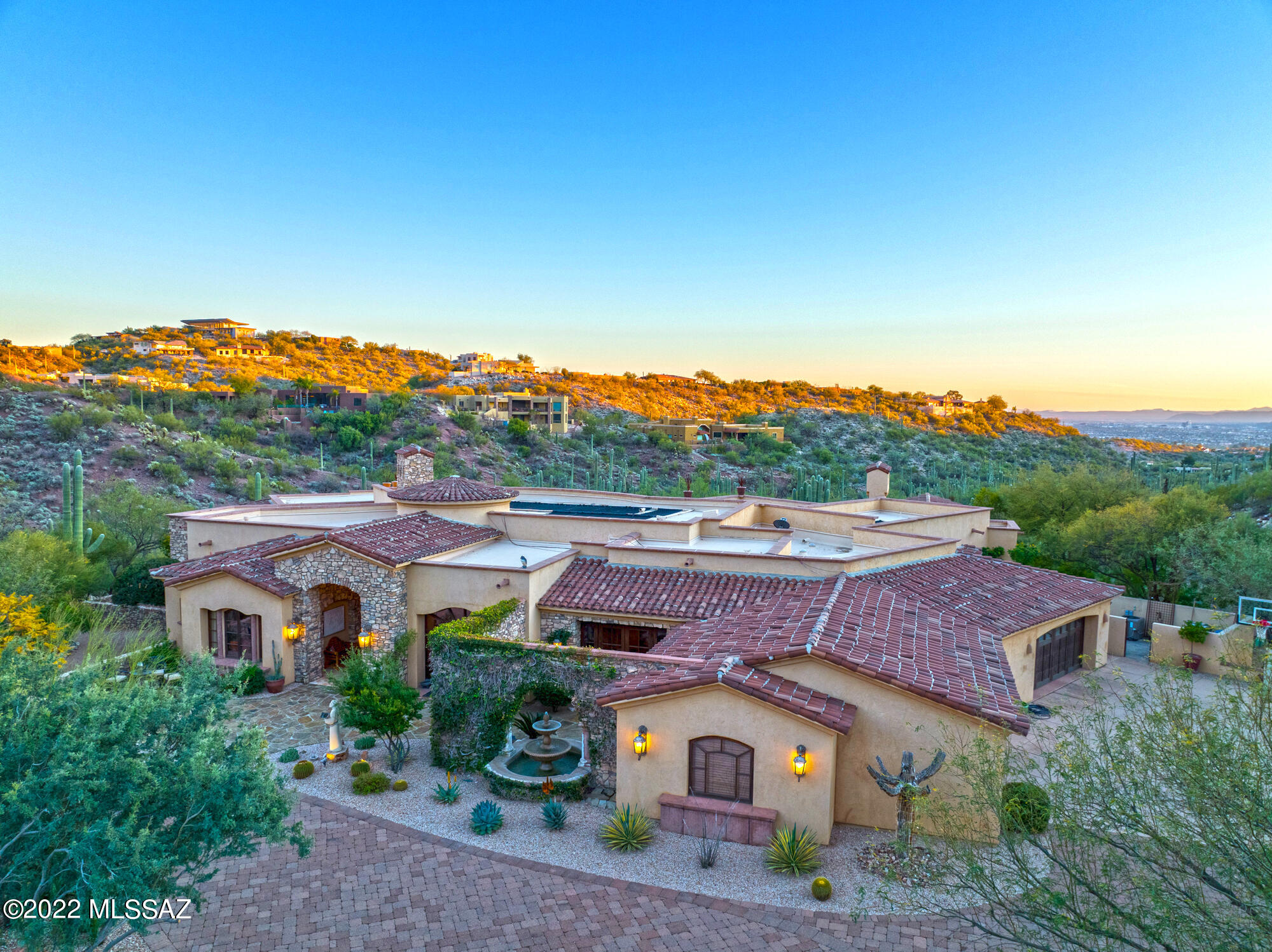 One of a kind masterpiece! This custom home is filled with architectural detail, custom amenities and great separation of space. A private master wing on the west side of the home, A guest/family wing on the north east side has 3 ensuite bedrooms. A complete wet bar with wine refrigerator, ice maker, and custom cabinets. A den adjacent to the bar that has a copper and wood beam ceiling. A two sided fireplace surrounded by a rock wall connects the expansive great room with the den and bar.
Formal dining, an office and a large laundry room with lots of storage. The truly gourmet kitchen has two large islands both with sinks and dishwasher, 2 refrigerators with freezer drawers, a warming drawer, ice maker and of course a chef's style Dacor range. All of
this and several outdoor areas to enjoy, a private courtyard off the office, a mountain view patio off the entry, and an expansive covered rear patio complete outdoor kitchen, fireplace, expansive views of the sunset and city lights/valley. And to complete the backyard there's a custom pool and spa area with water features and plenty of room to swim laps. See the list amenities under documents. All A/C units were replaced in 2018!