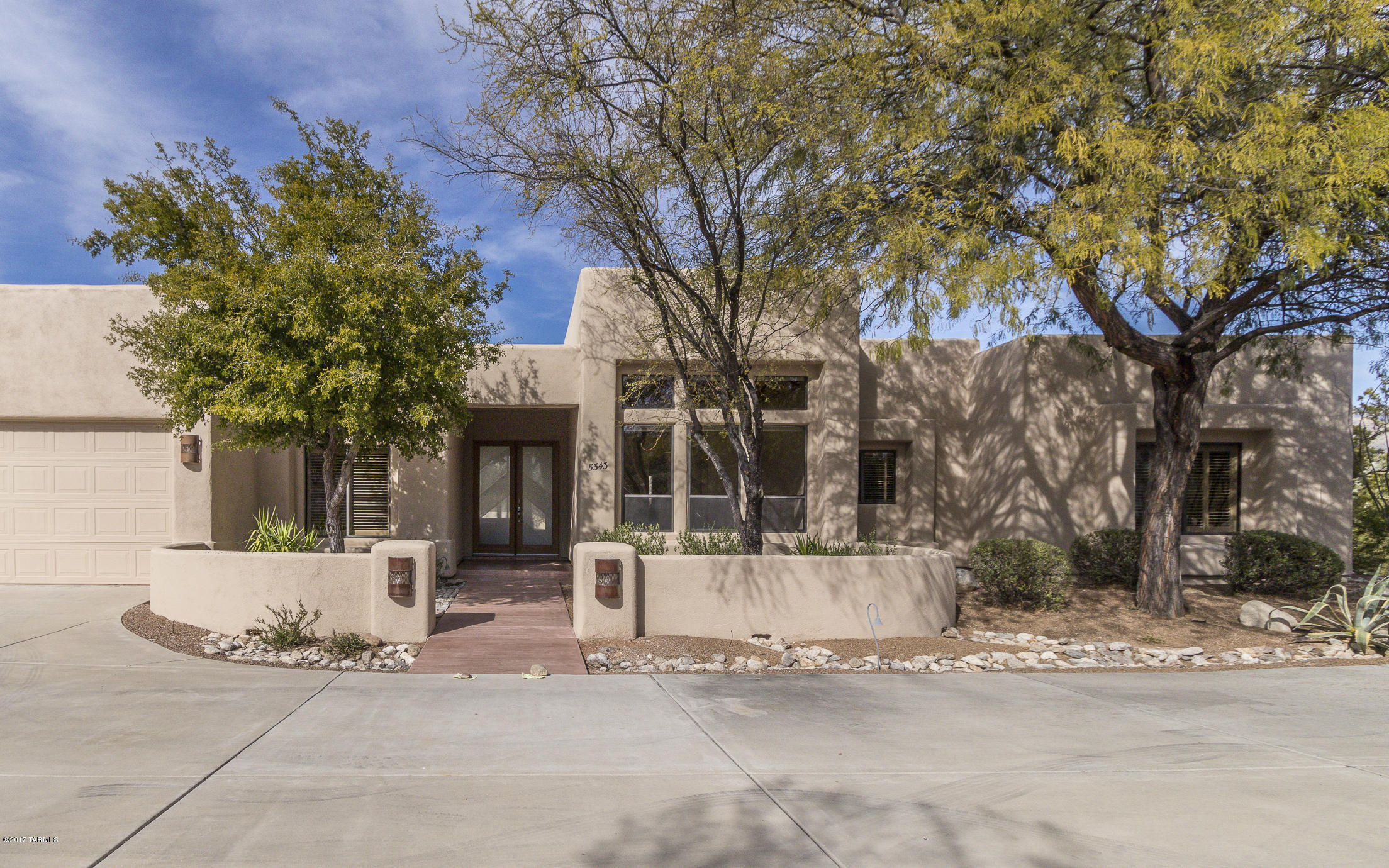 NEW DRASTICALLY REDUCED PRICE! Large contemporary foothills district home with full, separate guest house including kitchen and bath. Main house is 3358 sq ft/guest house is 721 sq ft. 3 car garage plus storage. Private, upscale neighborhood south of Ventana Canyon. District 16 schools. Immaculate, split plan, vega beams, granite counters, SS appliances, tile floors, decorative niches. Two indoor fireplaces, outside kiva fireplaces, porches and pool with sweeping views of Catalinas.