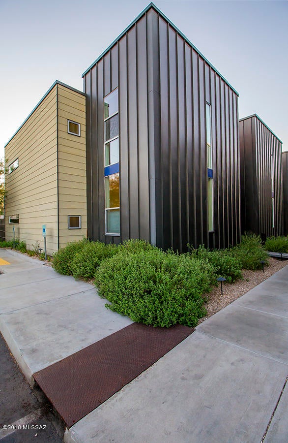 THE HOME...Lofty. light filled rooms,polished concrete floors,open kitchen with quartz counters,covered patio,observation balcony off master bedroom. A home you will enjoy now and well into the furture. Designed by architect Rob Paulus; award winning Indigo Modern.  An enclave of 11 energy efficient modern homes tucked away from the 3rd st. bike path.  This gated community was designed with an eye for the NOW and the FUTURE using materials that will last with minimum maintenance for years to come.  Water harvesting, highly insulated walls and ceilings owned PV solar, energy efficient HVAC  and appliances, community salt water pool.  Walk to Whole Foods, Loft Cinema, El Con.  Quick bike ride to U of A or Downtown.