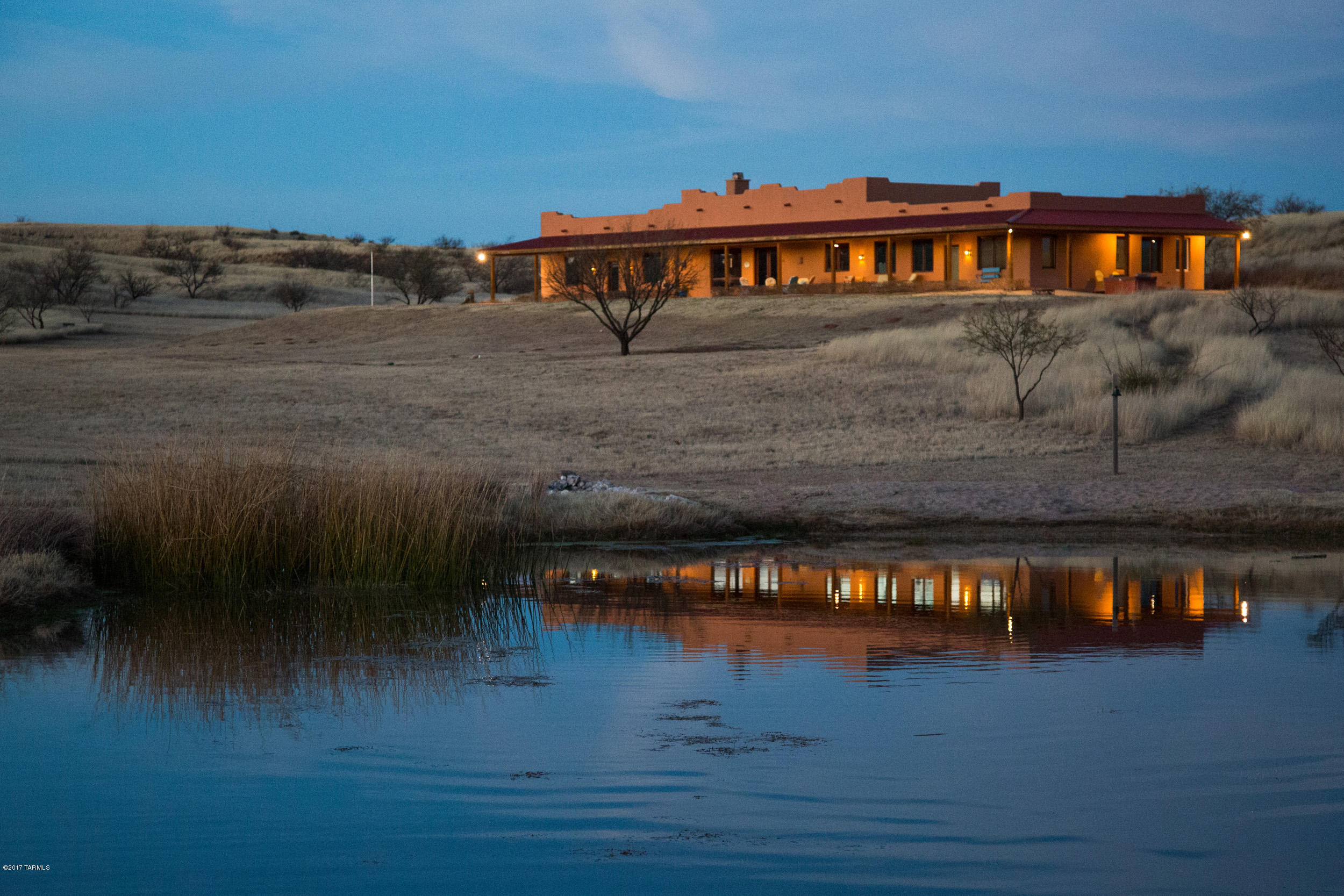 Ultimate in high desert living is found at this private & secluded property in gated community surrounded by natural beauty! Sited among the gentle rolling grasslands of Sonoita's finest, this ICF block superior constructed home offers plenty of outdoor recreation to include a heart shaped fish pond filled w/bass/blue gill/catfish, zip line site, pathway to perimeter fence bordering BLM Federal lands, large garden area, basketball hoop, RV hook-up & more! Massive great room w/large mesquite wood top kitchen bar/island, beautifully tiled cooking station, high ceilings, Den, Sewing/craft room & private Guest Quarters under roof. Large walk-in pantry, Built-ins, stained/polished concrete floors thru-out, wood interior doors, FP, oversize windows affords sunshine & incredible Mountain views!