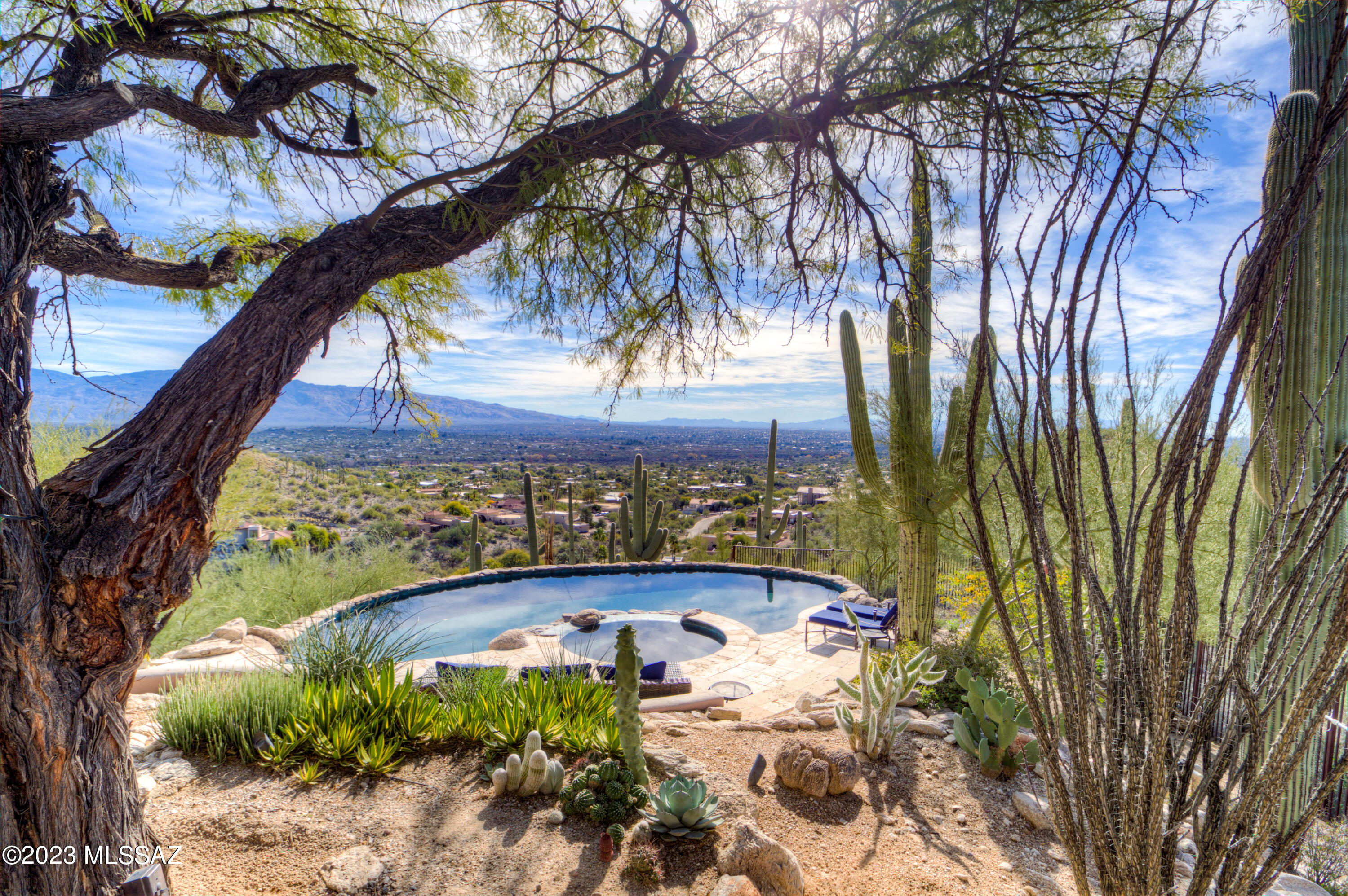 Sellers will accept or counter offers between $1,100,000 & $1,200,000. Breathtaking views with E/SE facing yard.  Enter the courtyard & into a freshly painted home where you will be greeted by spacious living & a split floor plan.   Large rooms with walk-in closets & views from all windows.  Stunning wood ceiling/beams with lots of natural bright light throughout.  Several access points to the backyard with flagstone walkways, pebble tech (solar) pool/spa, fountain and dog run on this saguaro studded lot.  See features list in documents.  Owner/Agent Seller is a licensed Commerical Broker in AZ.  NO POLY