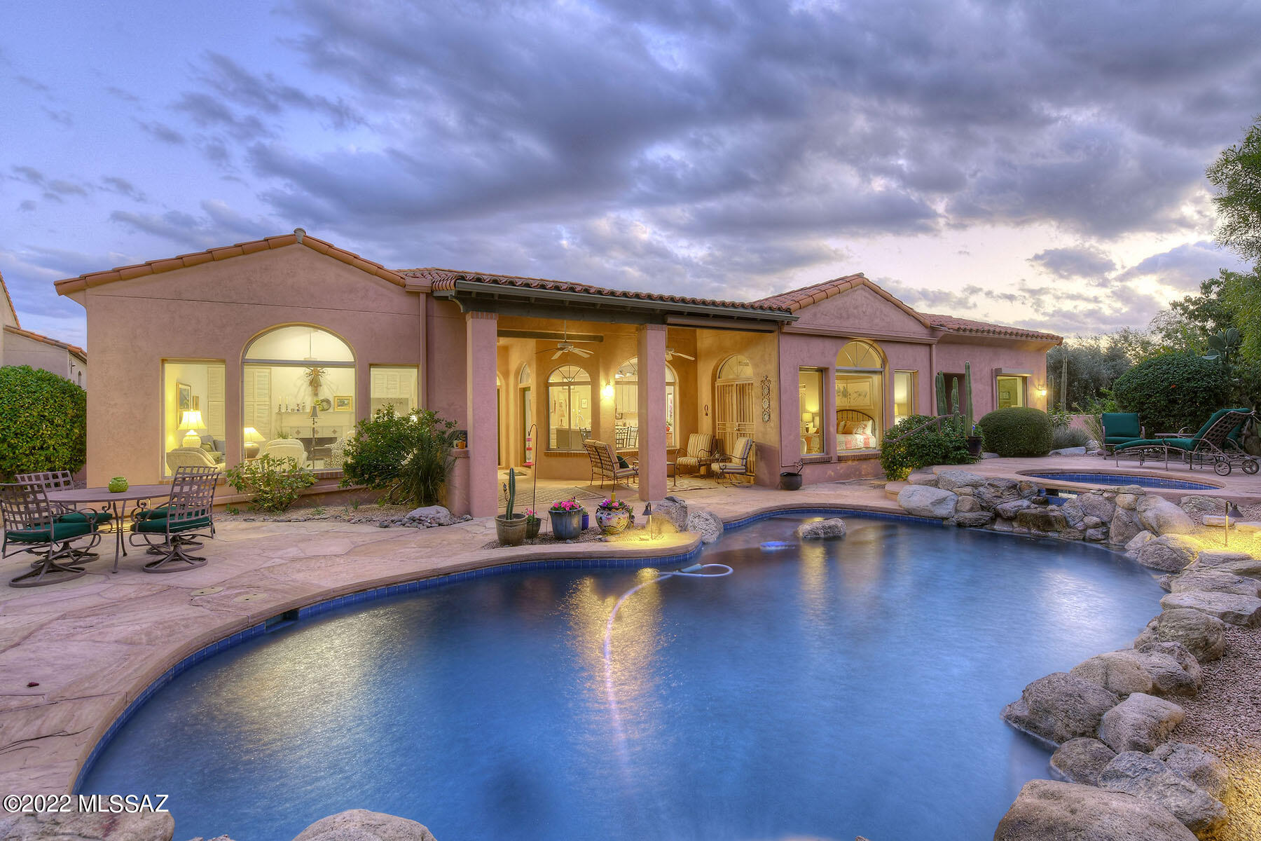 This wonderful all-masonry stucco home, built by David Baird, is on a cul-de-sac in sought after, gated Ventana Country Club Estates. The 2,960 sq. ft. residence, with no interior steps, offers 3 bedrooms plus a 11' 11'' x 18' 9'' office/exercise room. Highlights include a welcoming courtyard entry, an elegant dining room with coved ceiling, and a spacious living room complete with soaring cathedral beamed ceiling, a cozy fireplace, a wet bar and large picture window. The generous island kitchen provides granite counters, abundant cabinetry, stainless steel appliances, and a breakfast area. The inviting primary bedroom features patio access and a luxurious bathroom with a garden tub, a walk-in shower, dual vanities & a large walk-in closet. The office/exercise room, off the primary bedroom offers outside access. The comfortable den/2nd bedroom has extensive built-ins including a Murphy bed. Enjoy the private backyard featuring a porch area with concrete pavers & built-in barbecue, extensive use of flagstone flooring, lush plantings, a pool & spa, and sweeping mountain views. The property is conveniently located very close to Ventana Country Club, its amenities and the golf course.